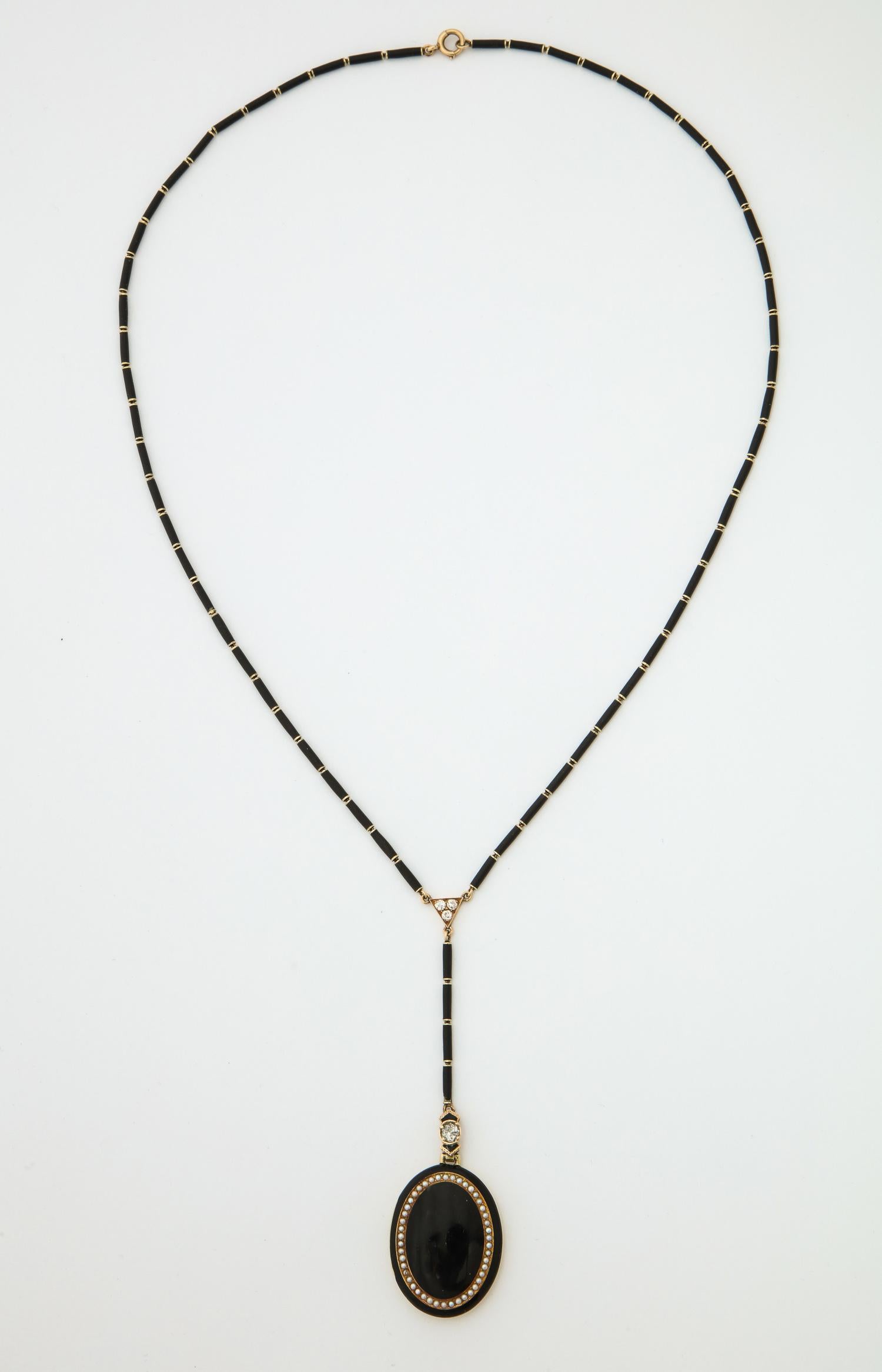 One Ladies Art Deco 18kt Gold Locket Necklace With Chain Designed In Black Enamel And Seed Pearls. Chain Has Four Antique Cut Diamonds .. Necklace Measures 20 inches And With Locket 26 inches Total Length.Spring Ring For Clasp Created In The 1920's