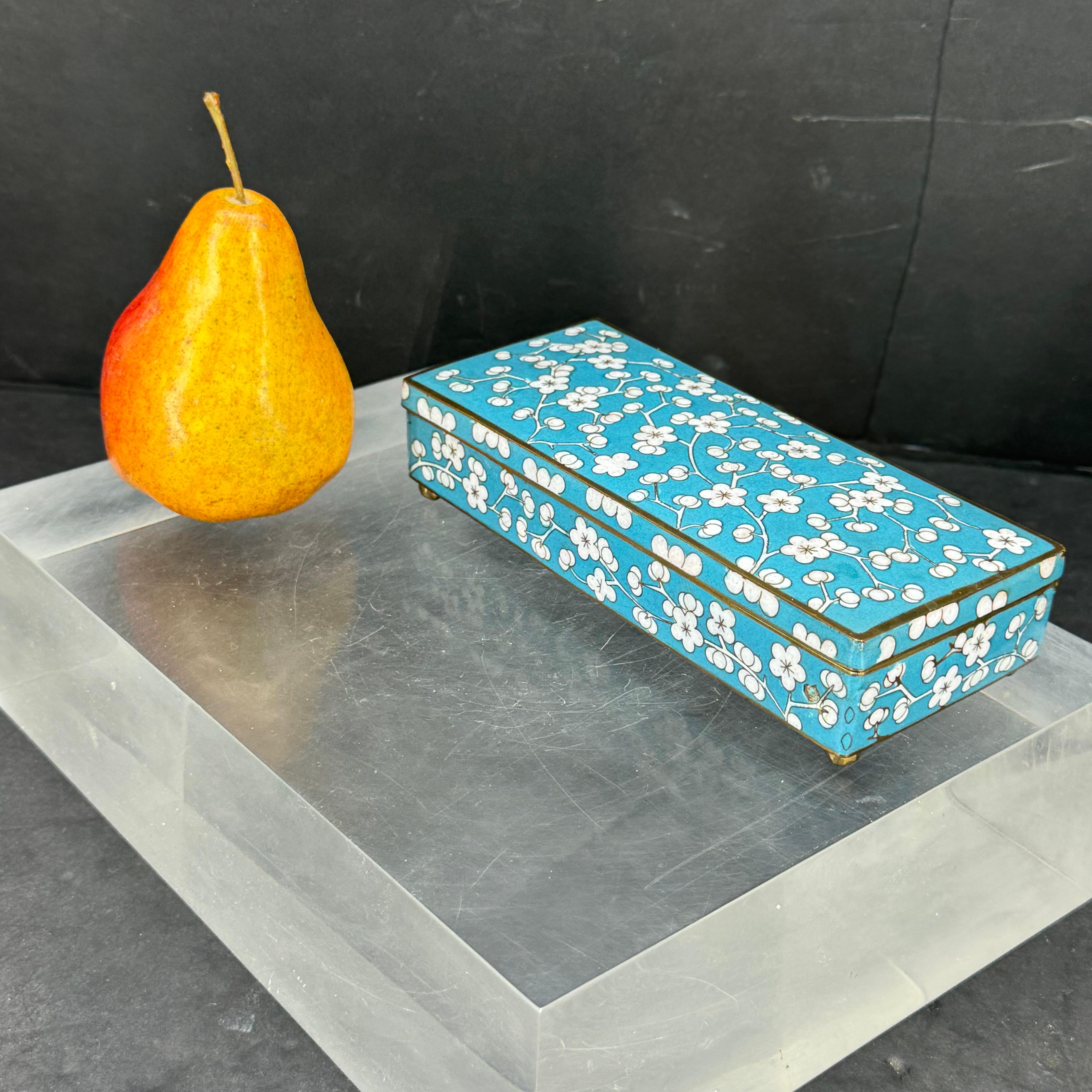 Very versatile 3 sectional box featuring cherry blossoms and teal cloisonné from the early 1900's. This teal colored enamel brass box is beautifully painted on the inside as well. Perfect piece for jewelry or trinkets as well as sitting alone on