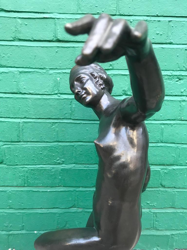 A 1920's original Art Deco bronze figure of dancing lady holding a ball on a Rosa Verona marble base. Signed.