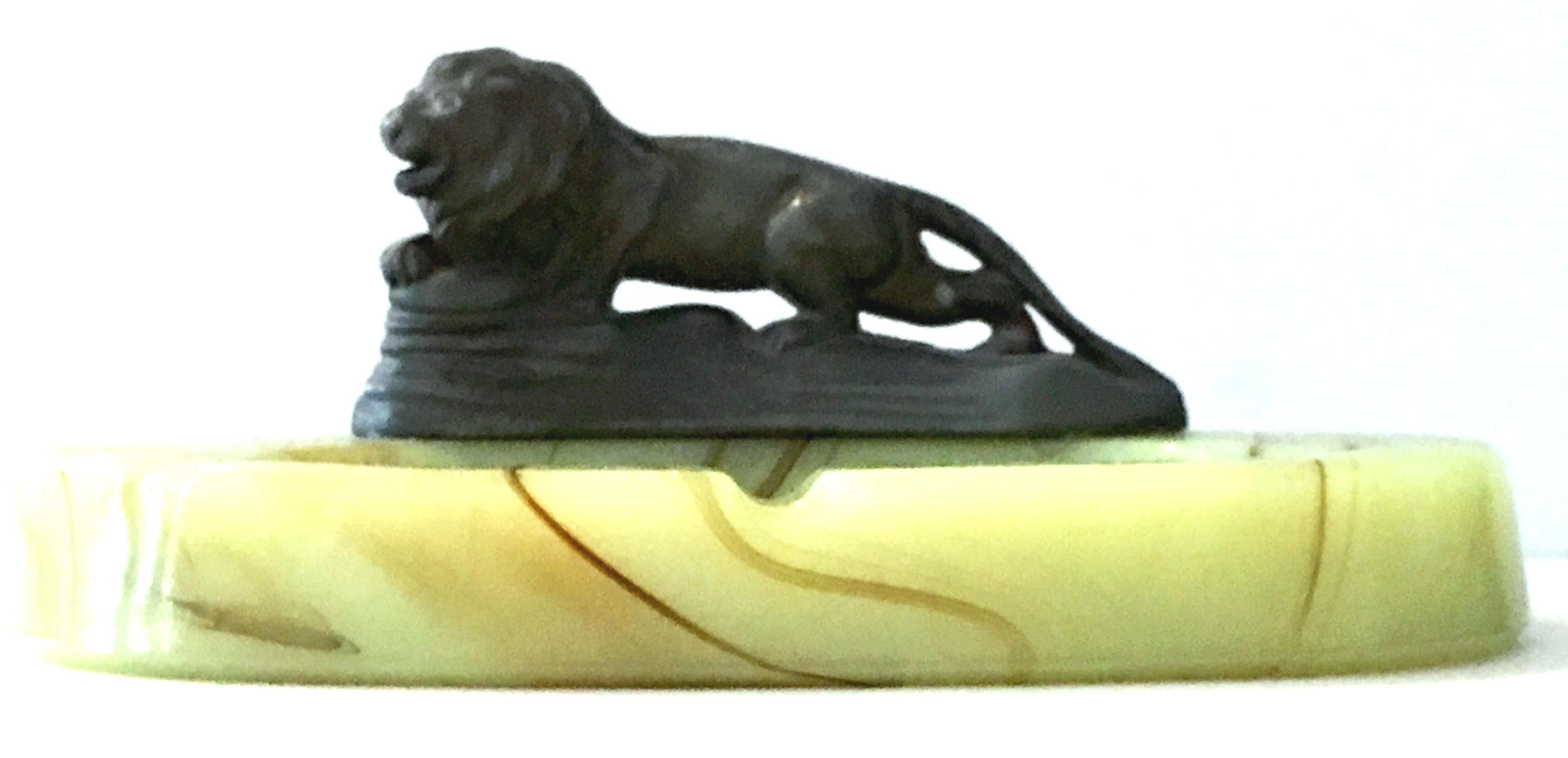 1920'S Art Deco bronze lion sculpture atop a oval green onyx catchall ashtray.