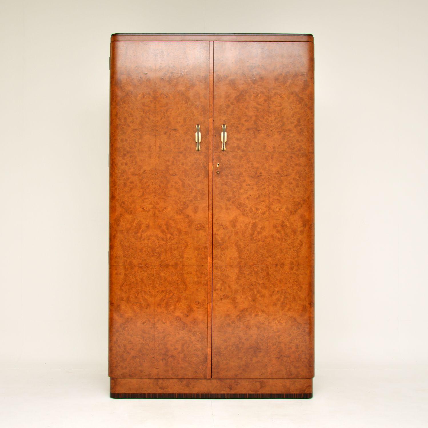 A stunning and extremely well made original Art Deco burr walnut wardrobe. This was made in England, it dates from the 1920-30’s.
The quality is outstanding, this is very heavy and solidly built. The burr walnut veneers are gorgeous throughout,