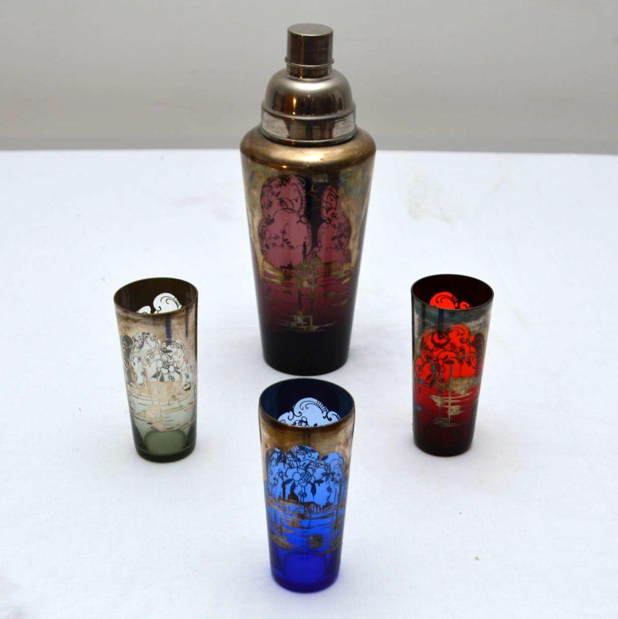 A quite stunning original Art Deco cocktail shaker and three matching glasses, these date from the 1920s-1930s. They are beautifully made from different colored glass, the condition is excellent for its age. The glass is decorated with stunning