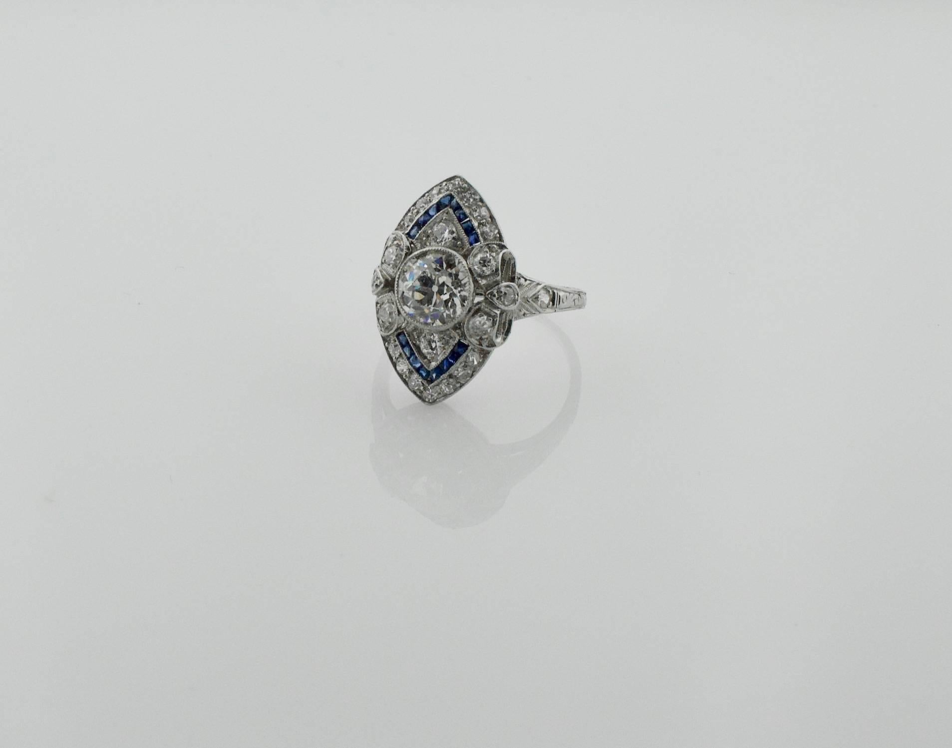 Diamond and Sapphire  Ring in Platinum
One Certified Old European Cut Diamond weighing 1.18 carats [J-VS2]
Twenty Four Old European and Single Cut  Diamonds weighing .70 carats approximately
Sixteen French Cut Calibrated Sapphires weighing .25