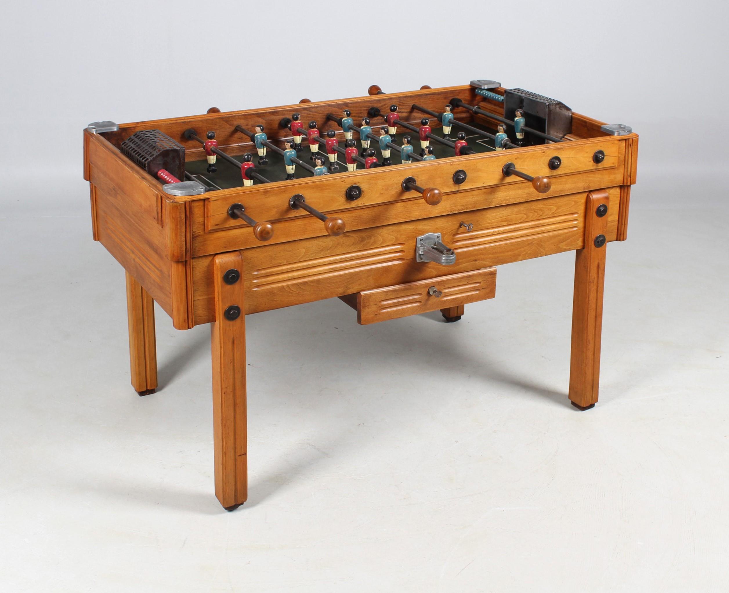 Antique foosball table

France
Beech
1920s - 1930s

Dimensions: H x W x D: 88 x 75 x 138 cm, handle height: 83 cm

Description:
Rare antique foosball table from the 1920s - 1930s.

The table is made of solid beech wood, the playing field is made of