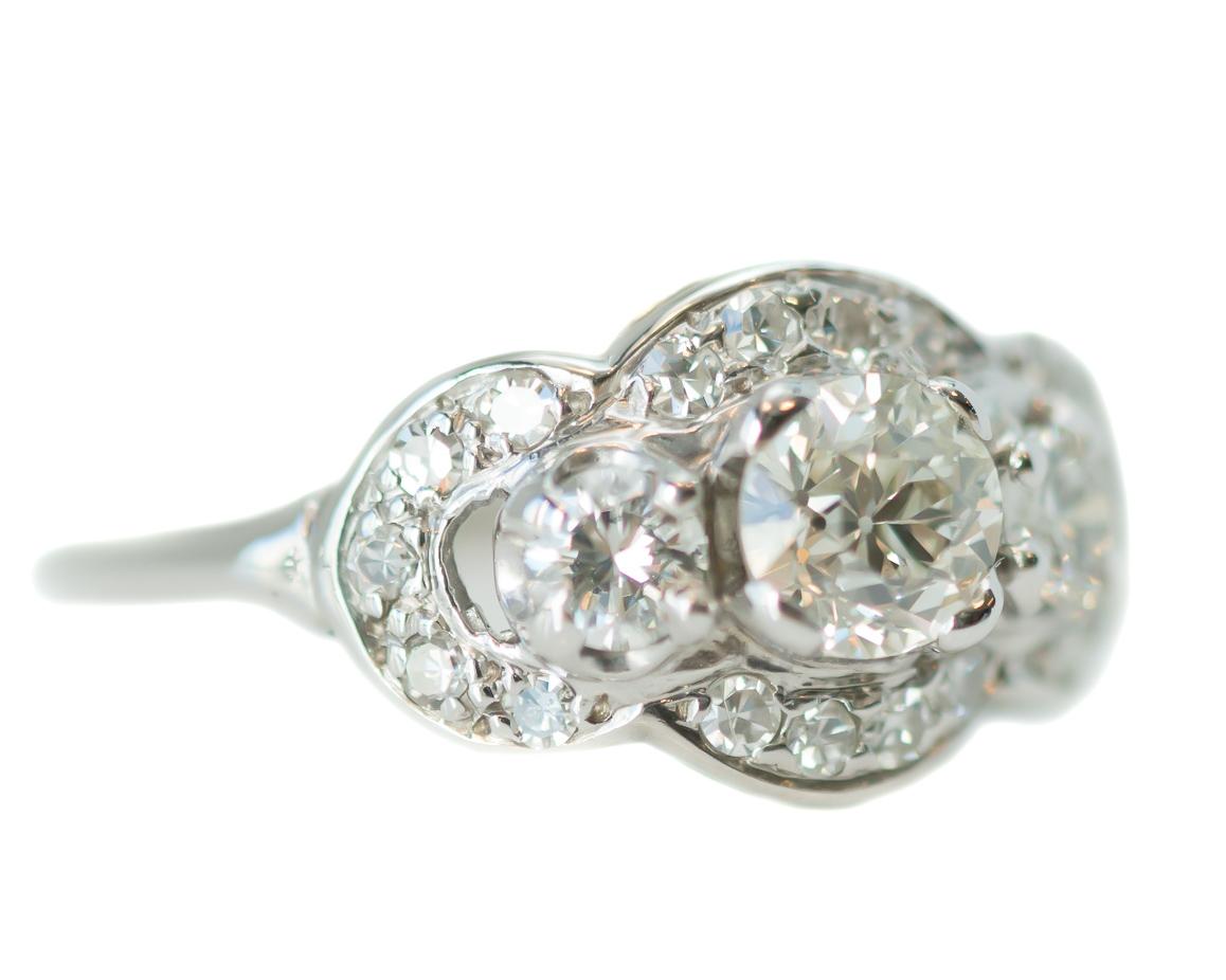Antique Art Deco GIA Old European Diamond Three Stone Ring - 14 Karat White Gold, Diamonds

Features
0.56 carat Old European Round Brilliant Diamond Center Stone
0.69 carat total Old European Round Brilliant Diamond Side Stones
14 Karat White Gold