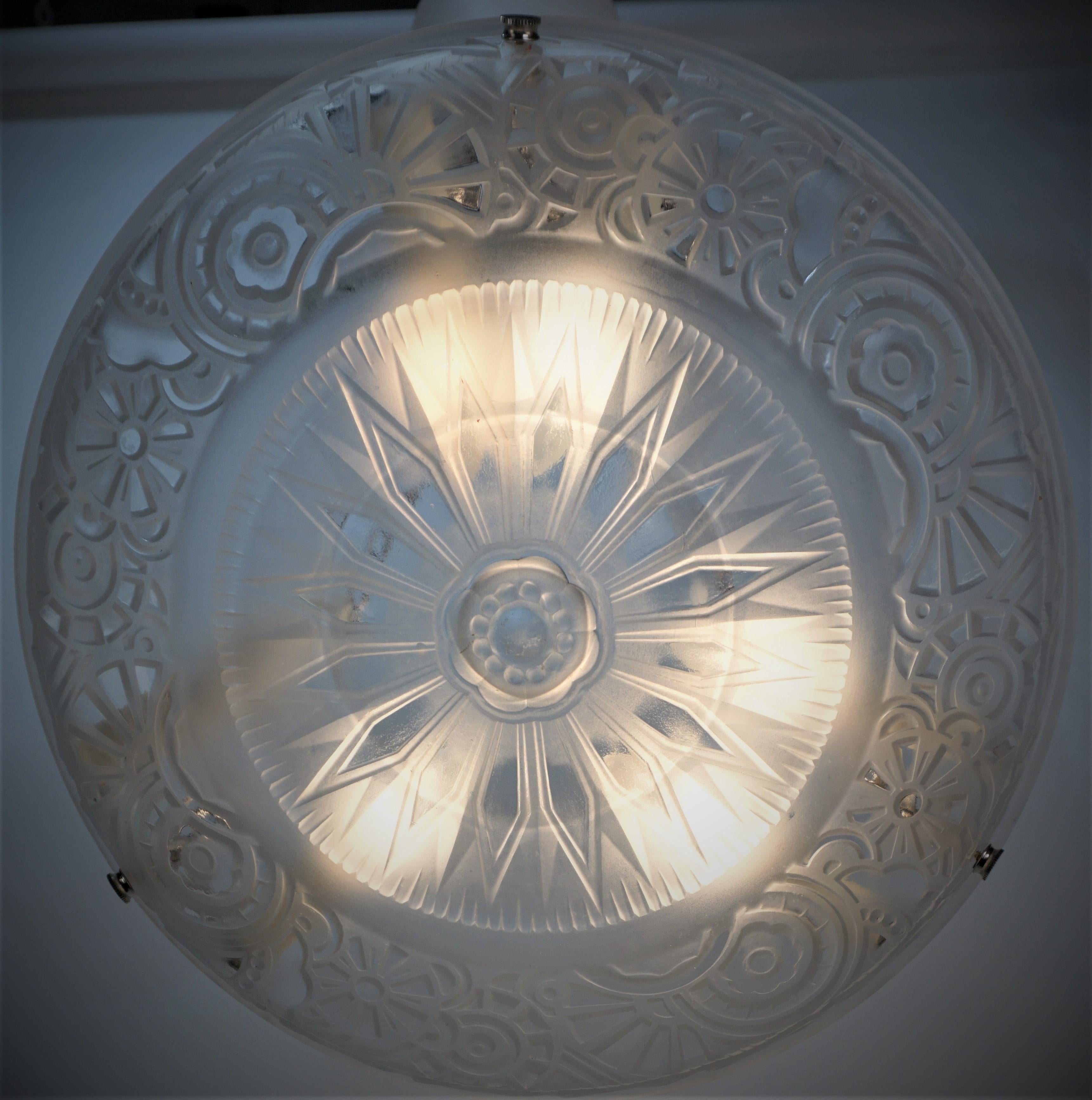 Beautiful clear frost geometric design with clear high light art deco chandeliers with nickel on bronze hardware.
Professionally rewired with six lights (60 watts max each) and ready for installation.