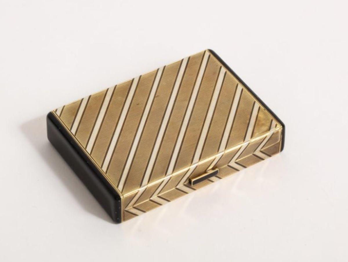 1920s Art Deco gold & enamel vanity case by Cartier 

Signed, Cartier & numbered 

Weight: 112.7 grams

Dimensions: Width 3 in, Height 0.44 in approximately

14 karat Gold

