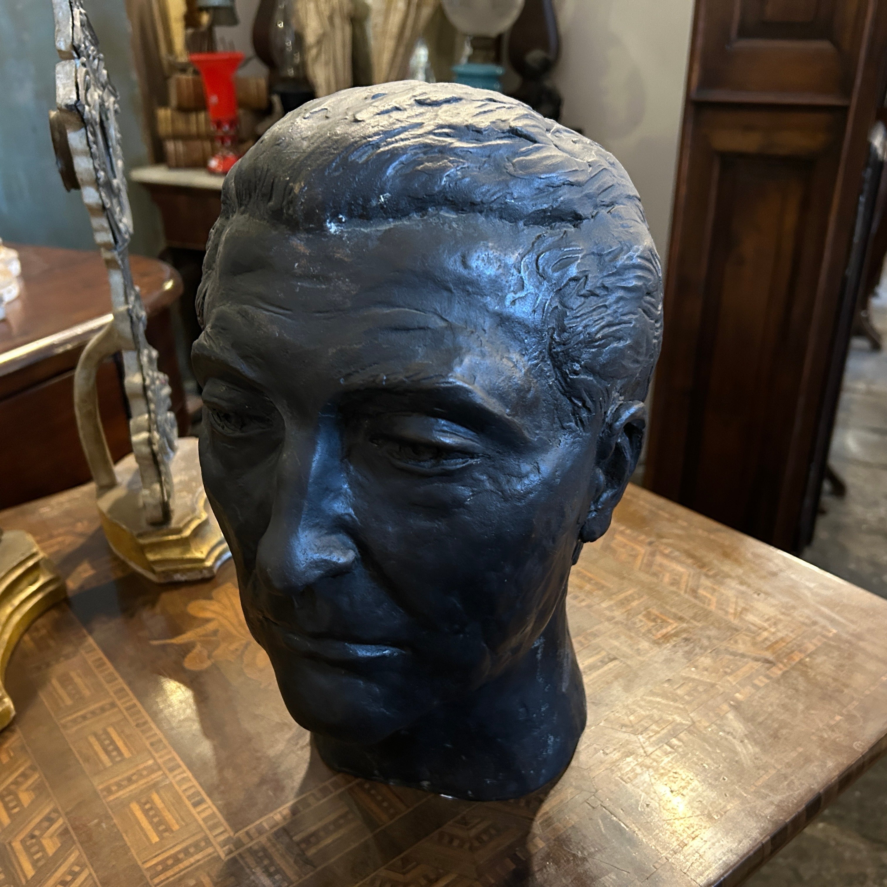 A 1920s Sicilian bronze head it's a sculpture created in the early 20th century on the island of Sicily. It has been cast from bronze, a durable and long-lasting Material, and shaped into the form of a head, with a lifelike appearance.
Sicilian