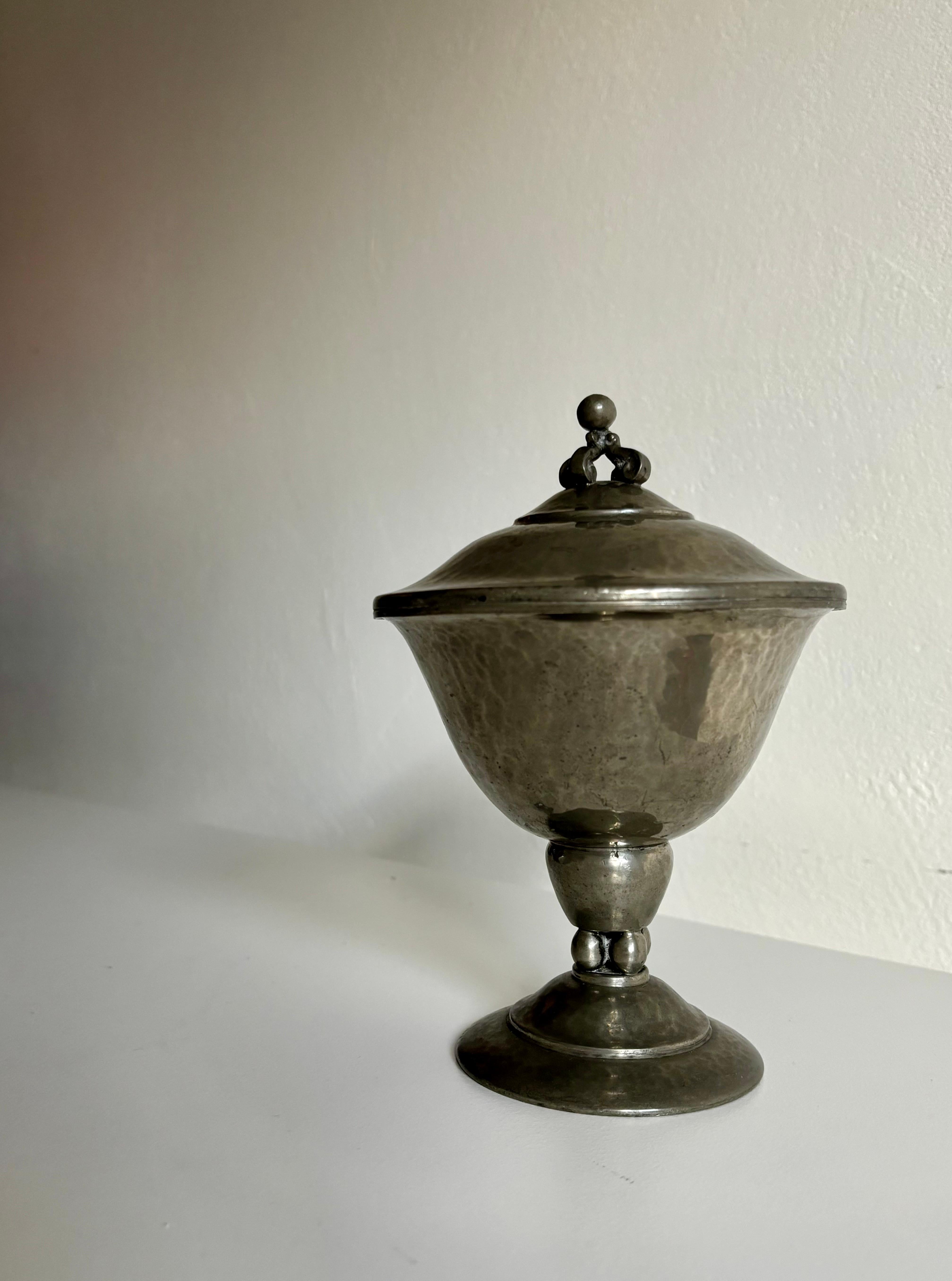 Antique 1920s Art Deco WG Tin pewter pedestal bowl with hammered surface and lid with crown decor. Sphere details on top and foot. Marked 
