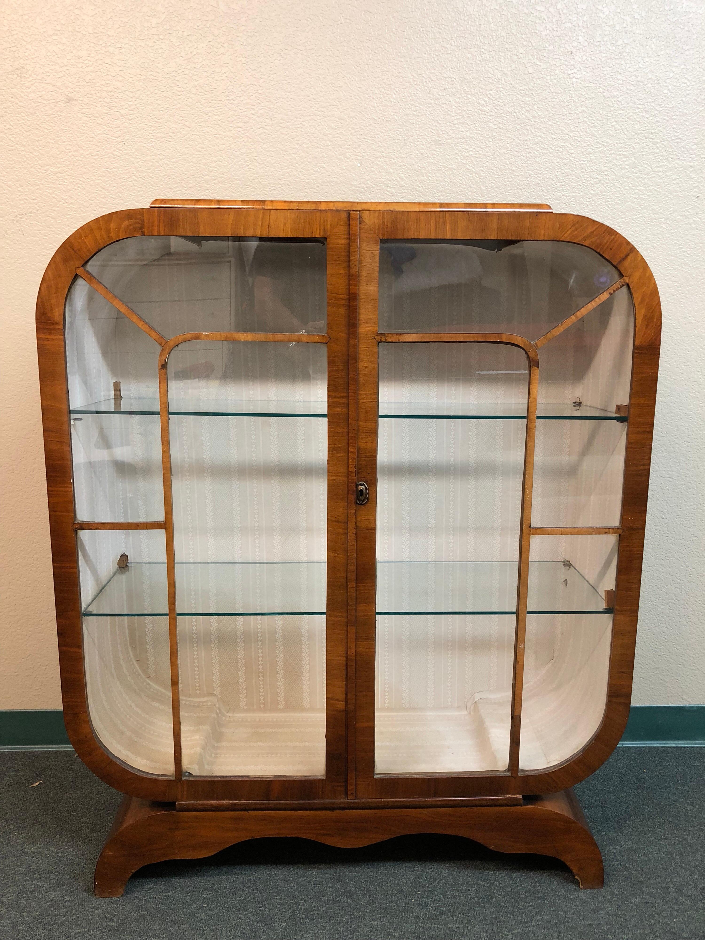 A beautiful display solution. Lovely mahogany veneers curve around your treasures with the lightest of ouch. Two fixed glass shelves. Lining is faded, veneer is stained on top.
 
