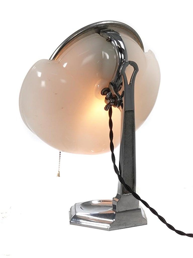 This is a rare Lapeer make up mirror lamp. They sometimes call the cloud lamp. The round articulated mirror sits against a milk glass lamp reflector. It gives off a perfect shadow less and even light. It’s a perfect bathroom or bedroom accessory
