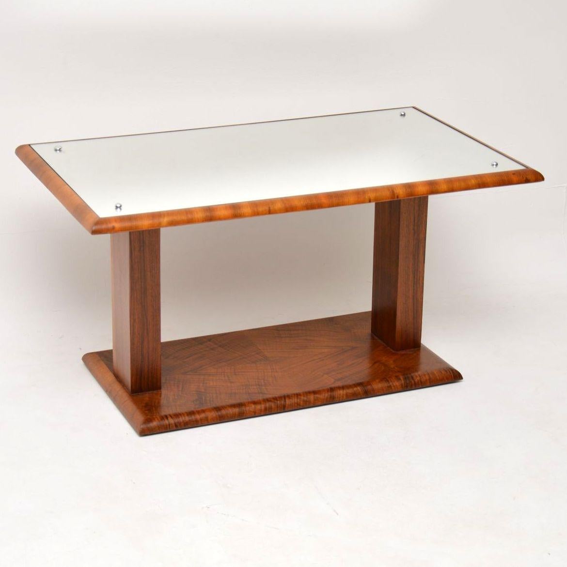 A beautiful original Art Deco period coffee table in walnut, with an inset mirrored top. This dates from the 1920-30’s, we have had it stripped and re-polished to a very high standard, the condition is superb throughout for its age. The colour and