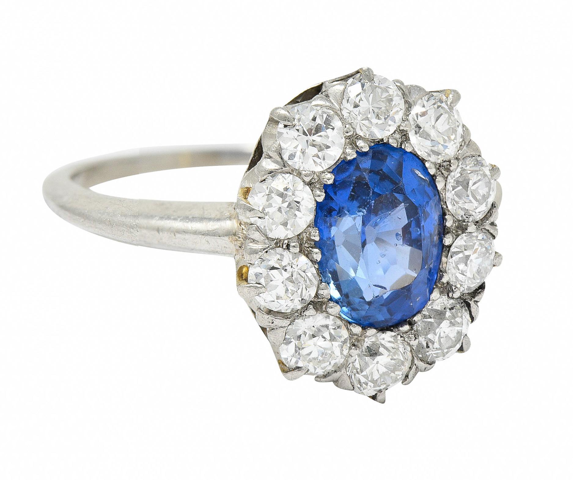 Cluster style ring centers an oval cut Ceylon sapphire weighing approximately 1.70 carats

Saturated violetish blue with no indications of heat - Sri Lankan in origin

Surrounded by old European and transitional cut diamonds

Weighing in total