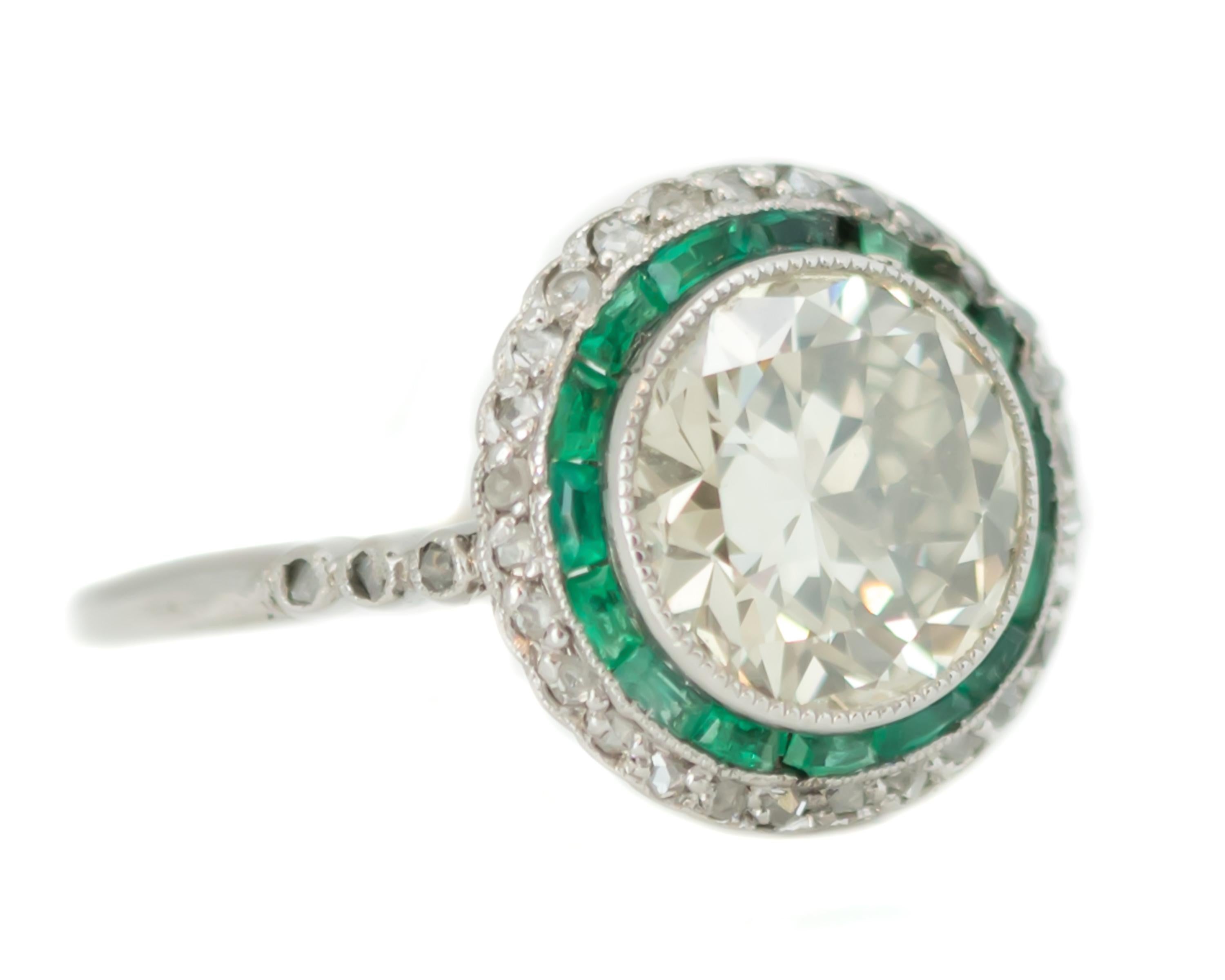 1920s Antique Diamond and Emerald Halo Ring -Platinum, Diamonds, Emeralds

Features:
2.59 carat Old European Center Stone
Baguette cut Emerald Halo
Single cut Diamond Halo
Platinum Setting

Bezel set Center Diamond
Channel set Emeralds
Prong set