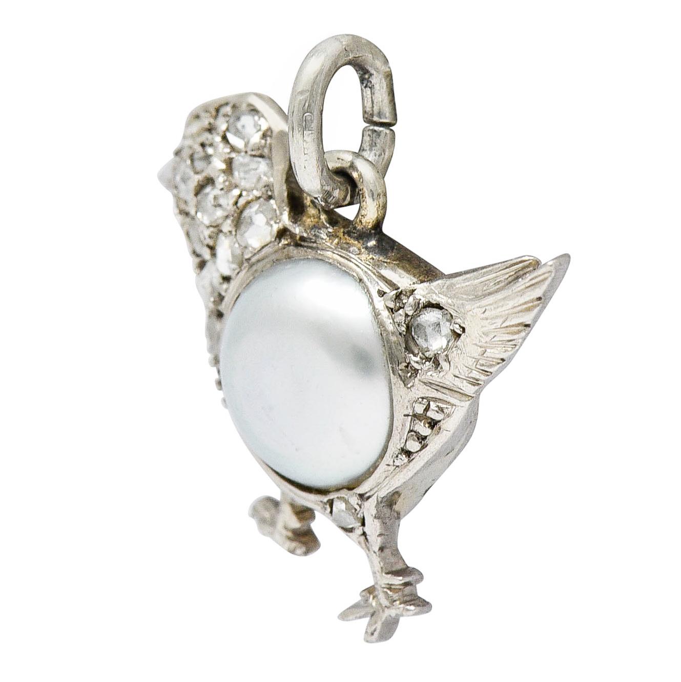 Charm is designed as chick centering a 6.0 mm mabe pearl

Gray in body color with strong iridescence and excellent luster

Accented by rose cut diamonds weighing approximately 0.17 carat

Tested as platinum

Circa: 1920s

Measures: 5/8 x 5/8