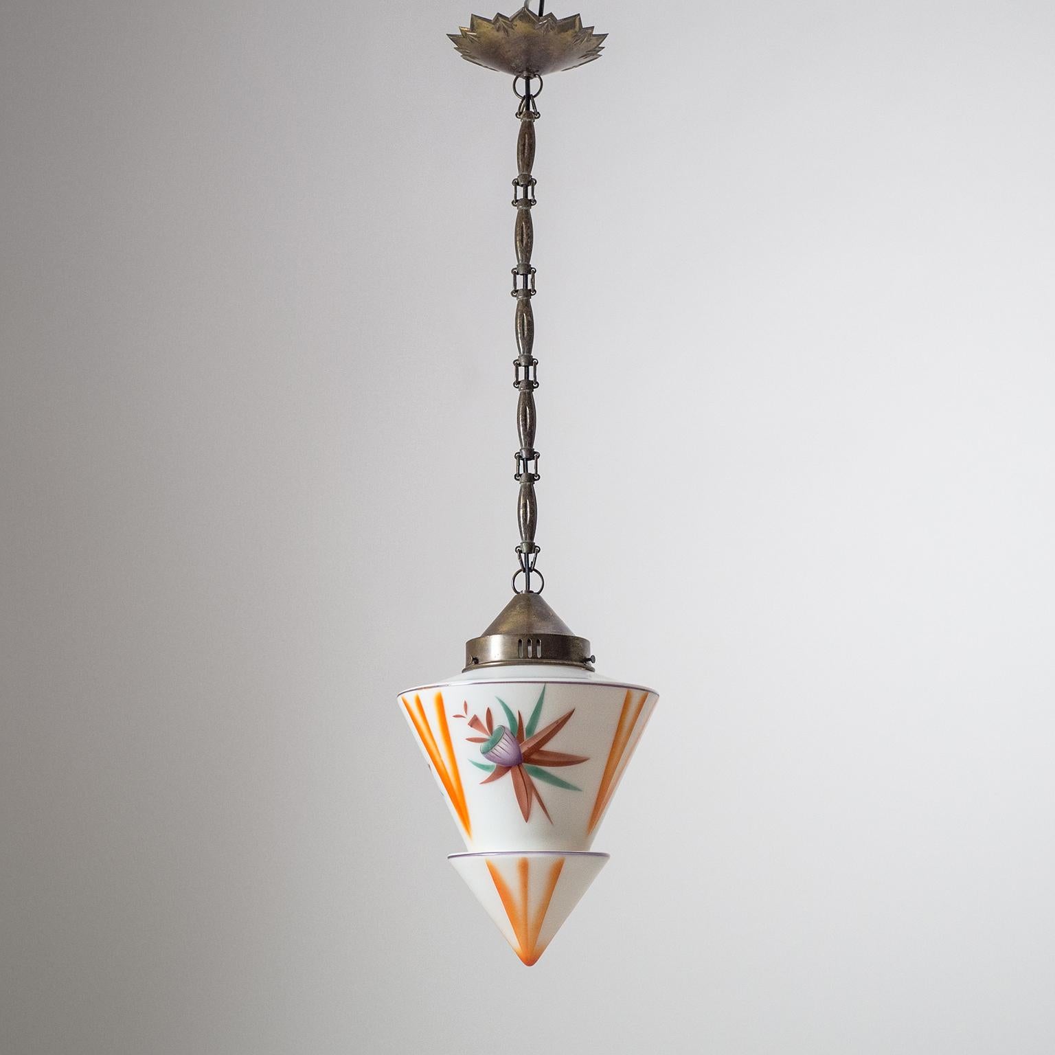 Rare and very unique Art Deco pendant, circa 1920, with enameled glass and brass. The tiered conical satin glass diffuser has an abstracted floral decor applied in aerography technique (an early precursor to airbrushing). Very nice original