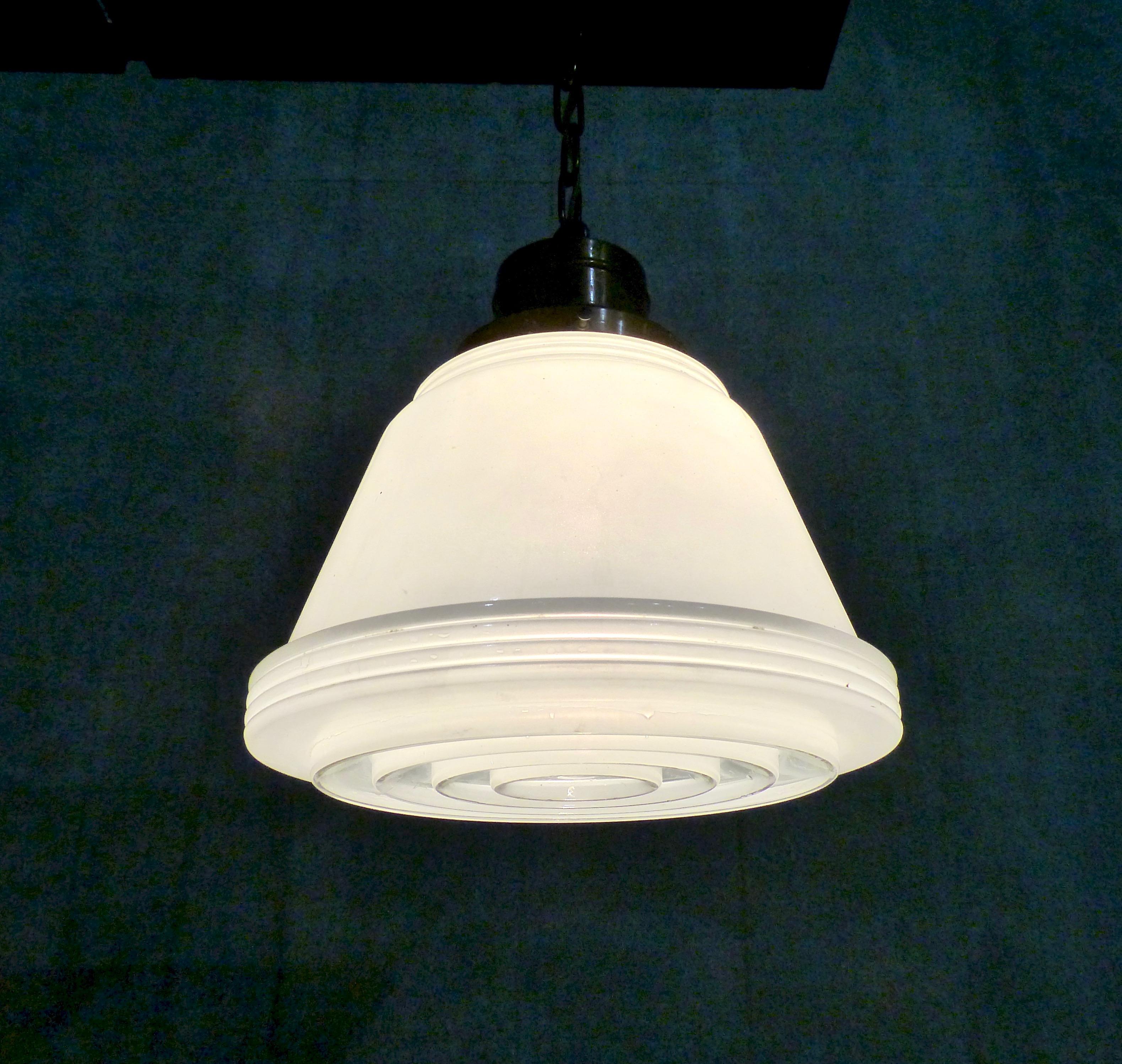 Rare and beautiful Art Deco pendant light with a milk glass shade (with ribbed elements) along with a clear and milk glass ribbed diffuser. Original copper fitter with chain. Re-wired and CSA approved to current electrical standards; ceiling