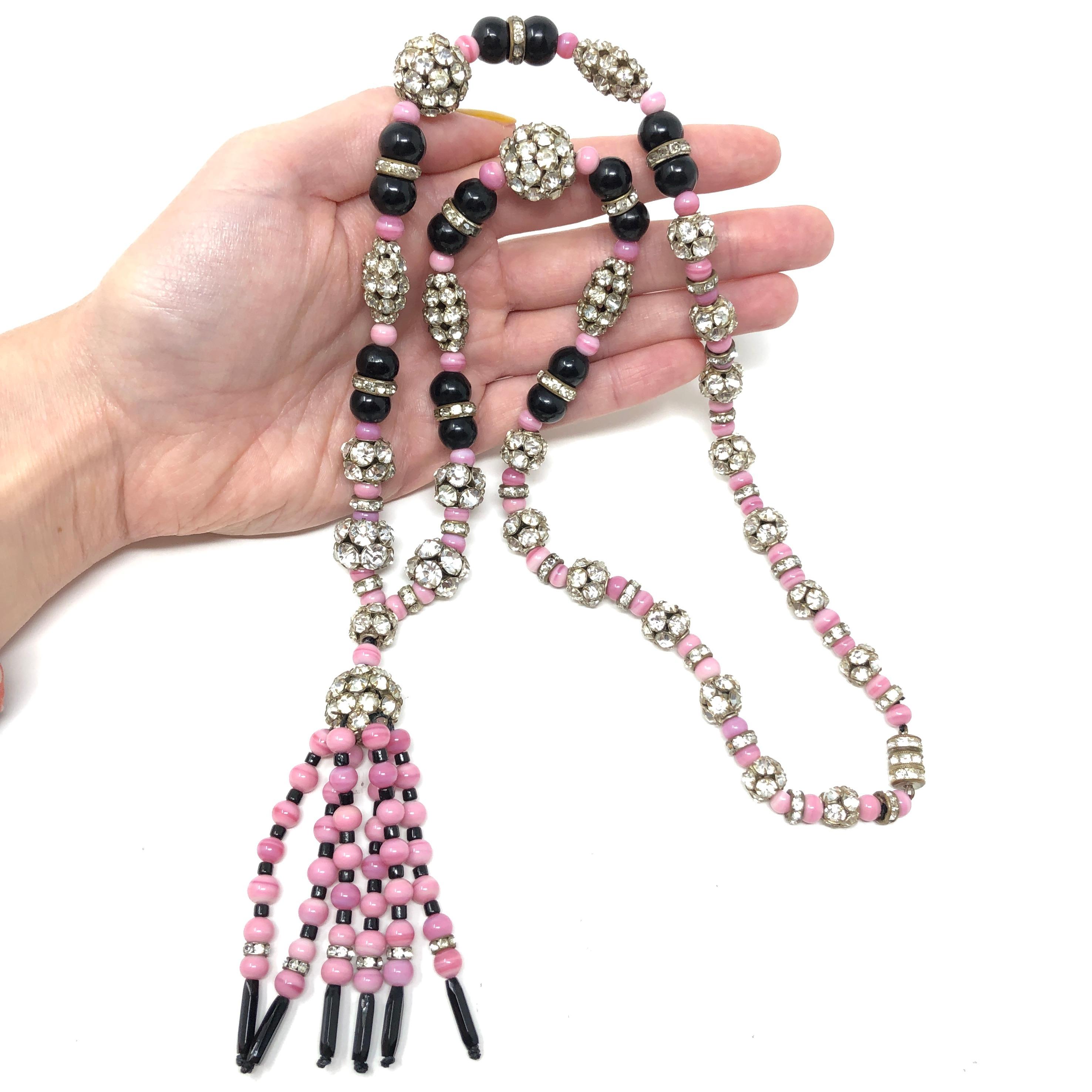 This rare and outstanding example of an Art Deco era flapper necklace was most likely created in France. 

Condition Report:
Excellent - The necklace has been professionally re-strung. 

The Details...
This necklace features round pink glass beads