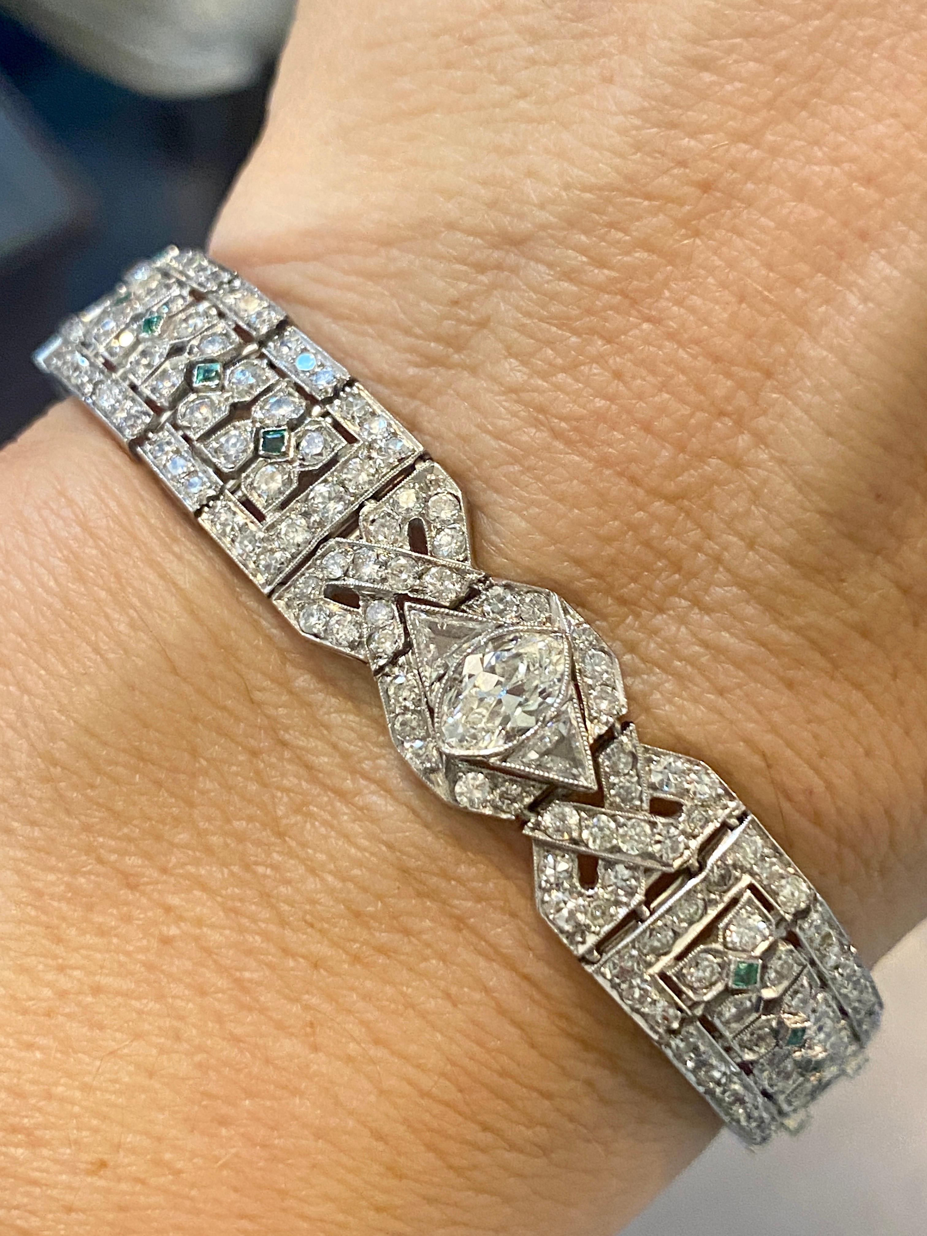 This exquisite Art Deco bracelet is made of platinum and adorned with approximately 10 carats of Old European diamonds. There are 2 prominent marquise diamonds one in the front and the other on the clasp which weigh approximately 0.75 carats each.