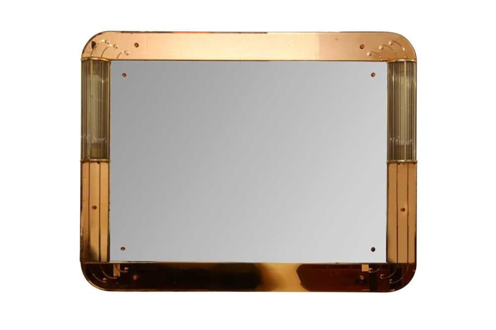 Art Deco Peach Glass Rectangular Bevel Edged Wall Mirror Peach Glass Has Etched Features & Rounded Corners

The Mirror is Flanked by a Pair of Lights with Shades Formed of Vertical Glass Cylinders 1920s

From the estate of Judith Found textile