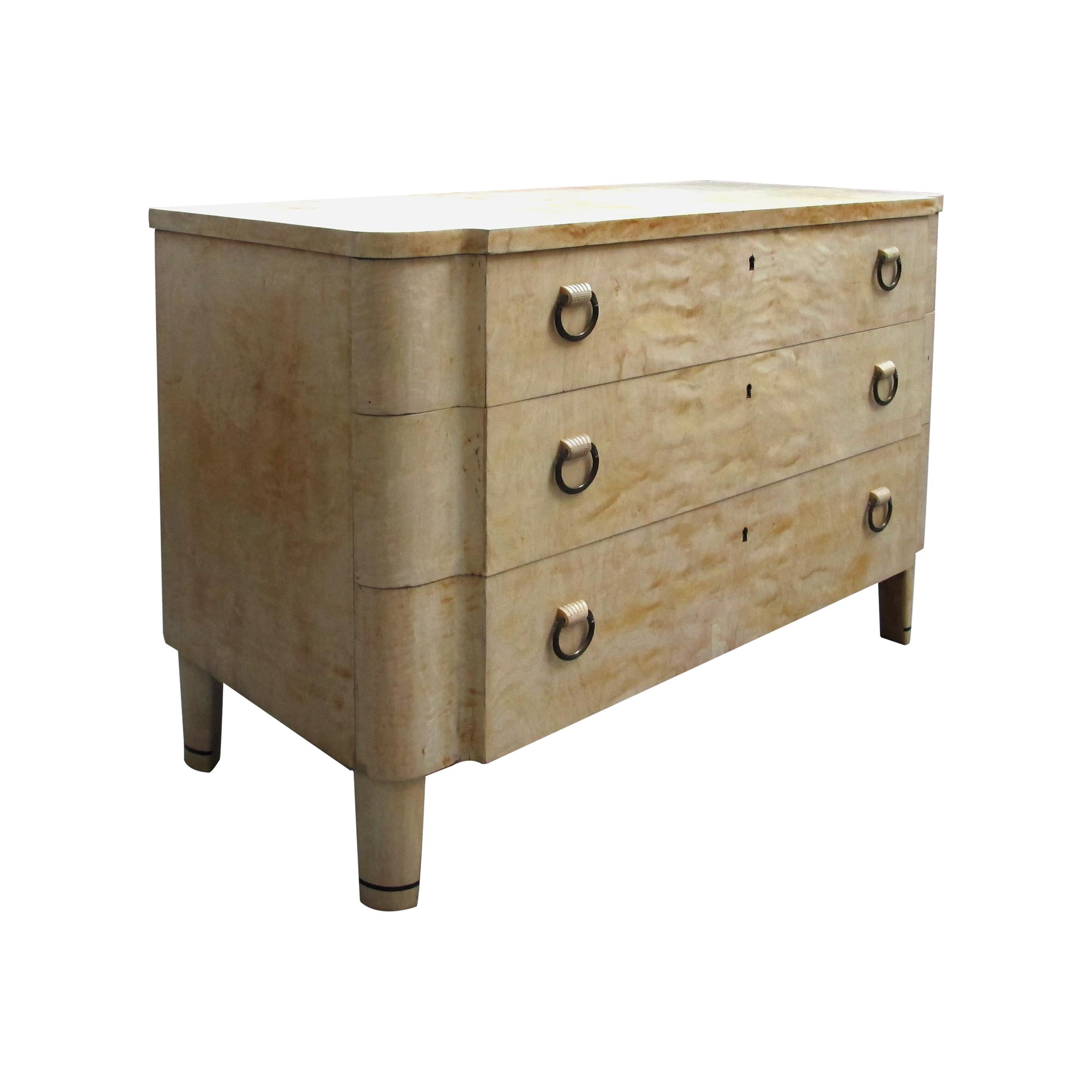 An elegant Scandinavian Art Deco chest of drawers with honeycomb Birch veneers, circa 1920s. The three equal size drawers are beautifully curved on the edges and all operated by the same key. Each drawer boasts its original brass handles which are