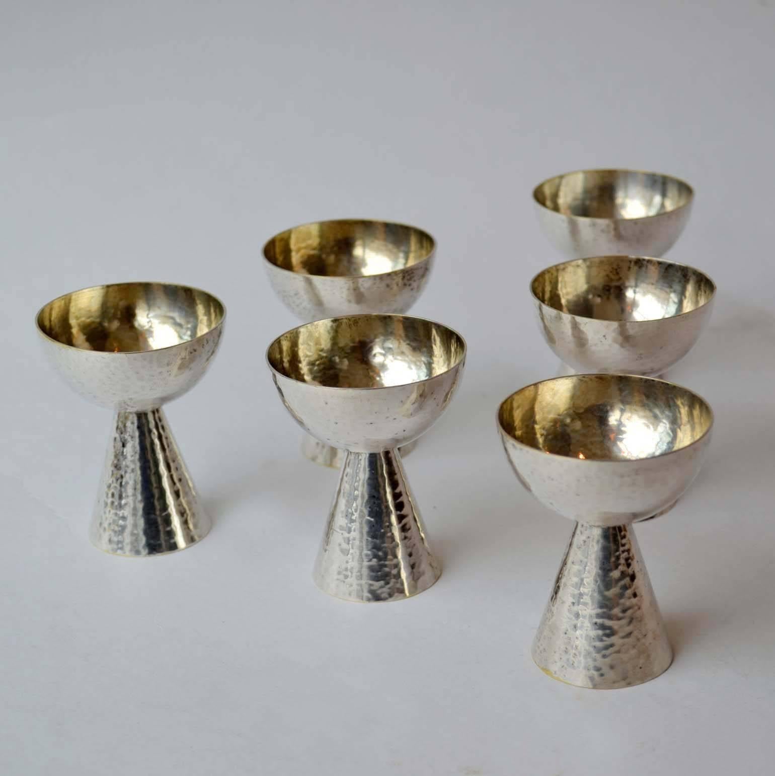 Hand driven set of silver plated liqueur glasses, based on geometrical forms. They are Art Deco made in Germany, 1920s.
    