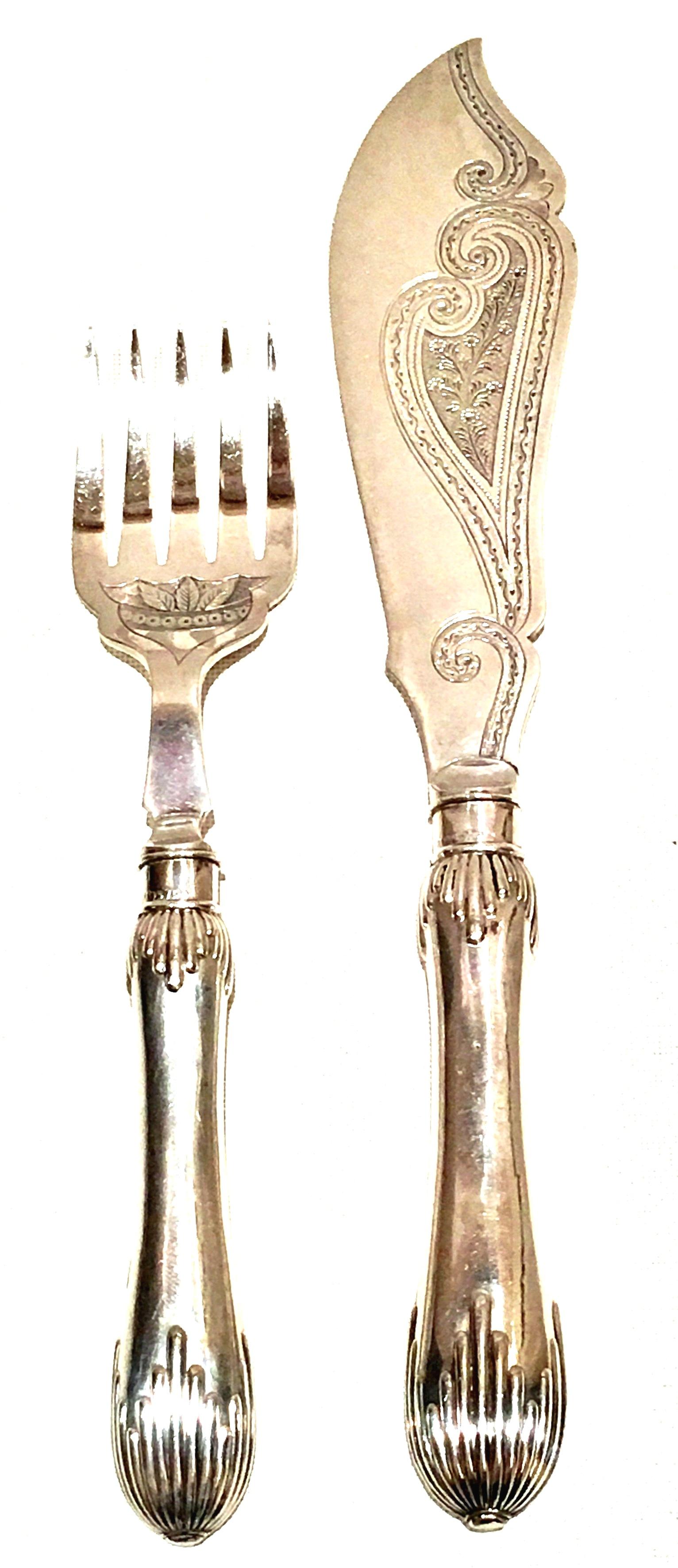 1920'S Sheffield England Silver Plate Art Deco fish serving fork and knife, two-piece set. Silver plate hallmarks by, Joseph Elliot & Sons, Sheffield England. Pattern of scroll and leaf engraved on knife blade and raised detail on handles. Fork