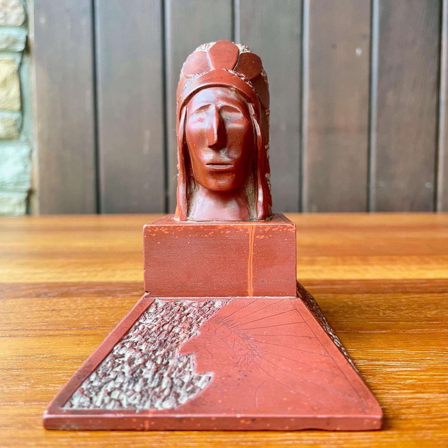 Most-likely was a route 66 touring souvenir from somewhere in the old west.  Almost geometric in its simplicity, and stylization.  Poured red stone marbilite.  Showing wear, and small hairline to first plinth, wear there is a stripe of