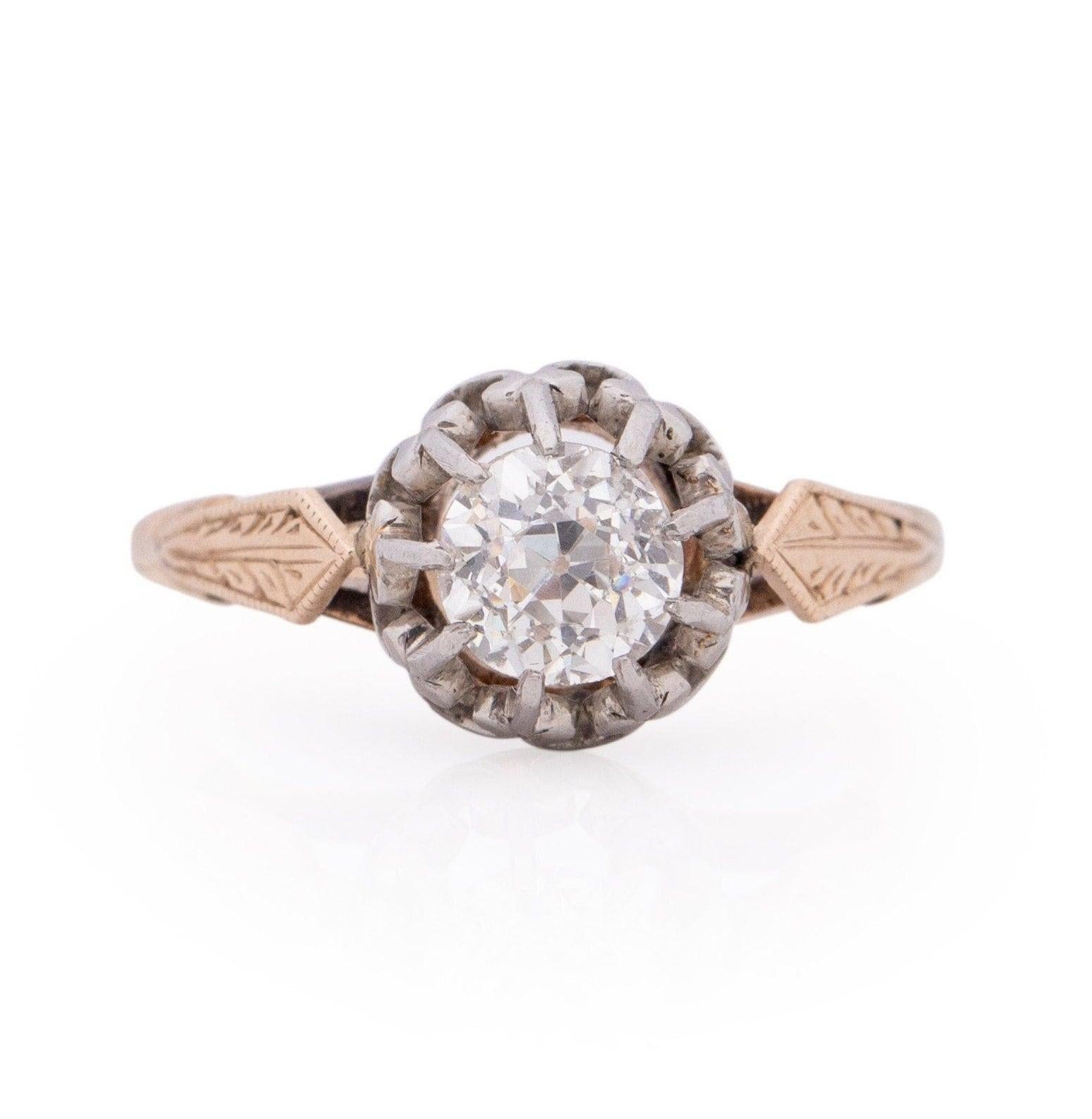 Presenting a truly distinctive work of art, this exquisite ring showcases a captivating duality of tones. Crafted from the elegance of 14K rose gold, the ring itself boasts a Fleur Di Lis-inspired prong design, meticulously fashioned from platinum,