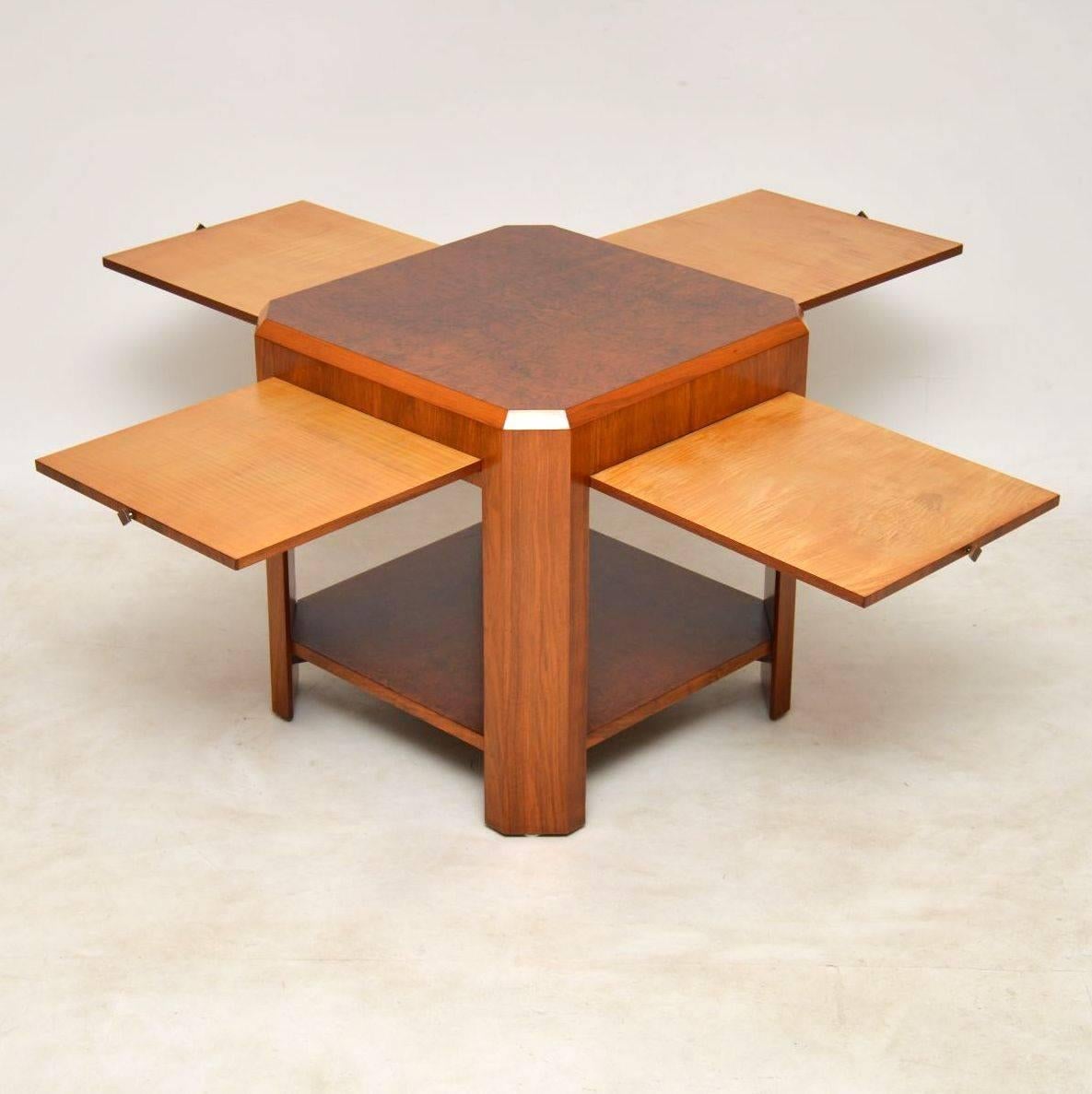 A stunning and extremely well made Art Deco table in burr walnut, this dates from around the 1920s-1930s. It has four pull-out slides, one on each side of the table, the slides are veneered in Sycamore. This is very solidly built and is very heavy