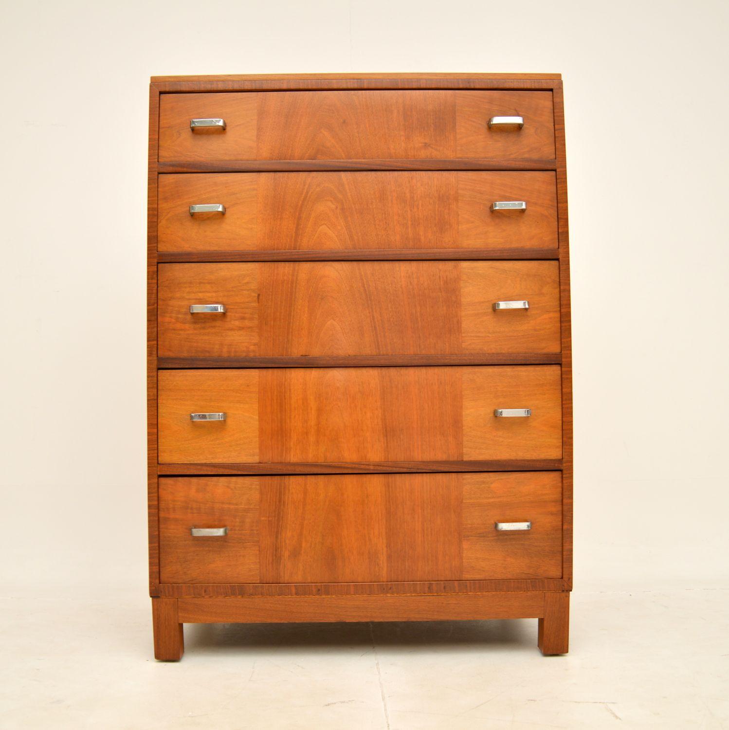 A stylish and extremely well made Art Deco period chest of drawers. This was made by and retailed in Heal’s in the 1920-30’s.

The quality is exceptional, with a very solid construction and gorgeous walnut grain patterns. There is lots of storage