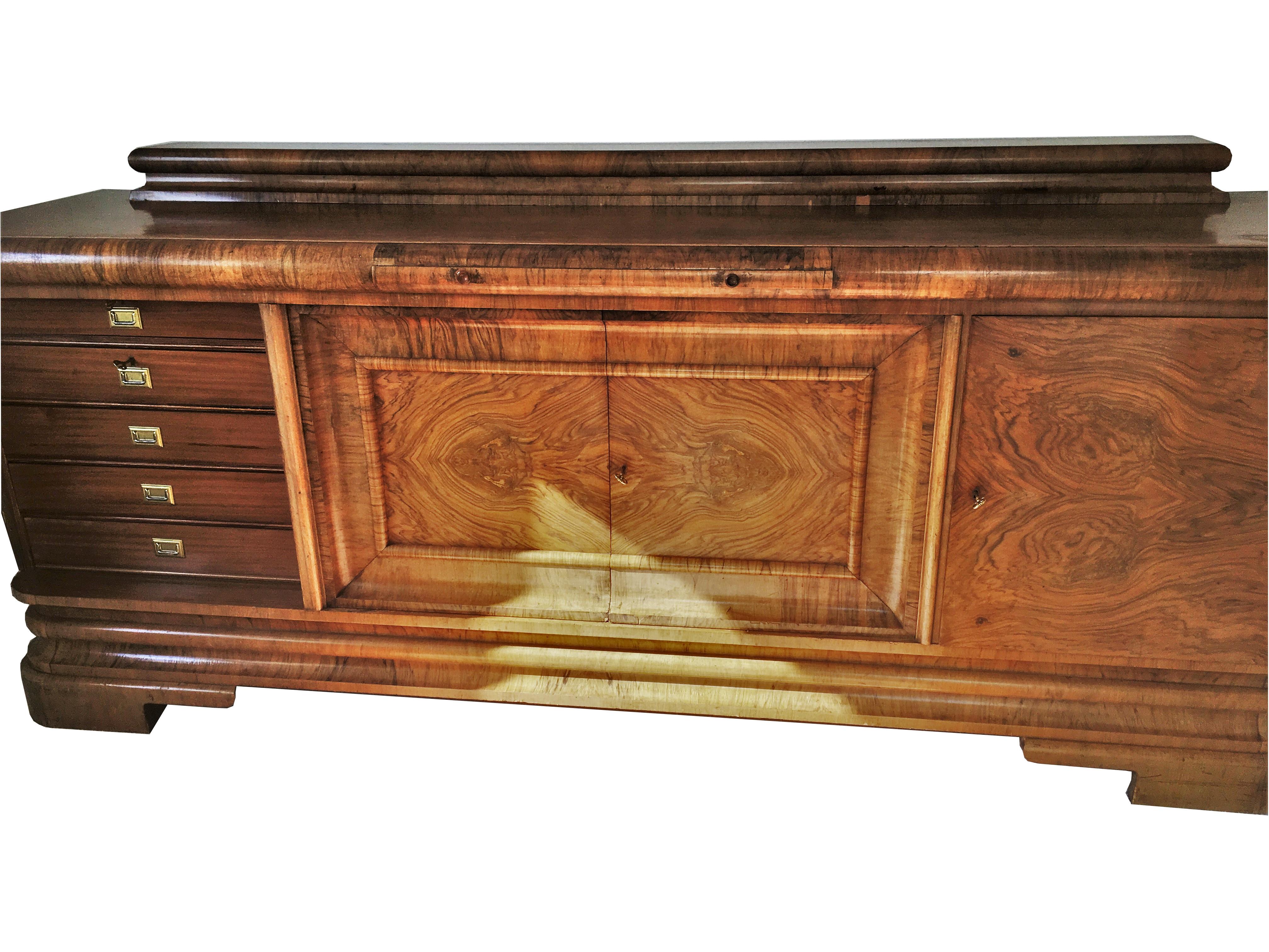 Wonderful 1920s Art Deco sideboard from Germany made of special walnut wood. Offers a classic design with four large doors and a red marble extension plate. On the top you will find a 11cm / 4? high hutch and on the inside five drawers as well as