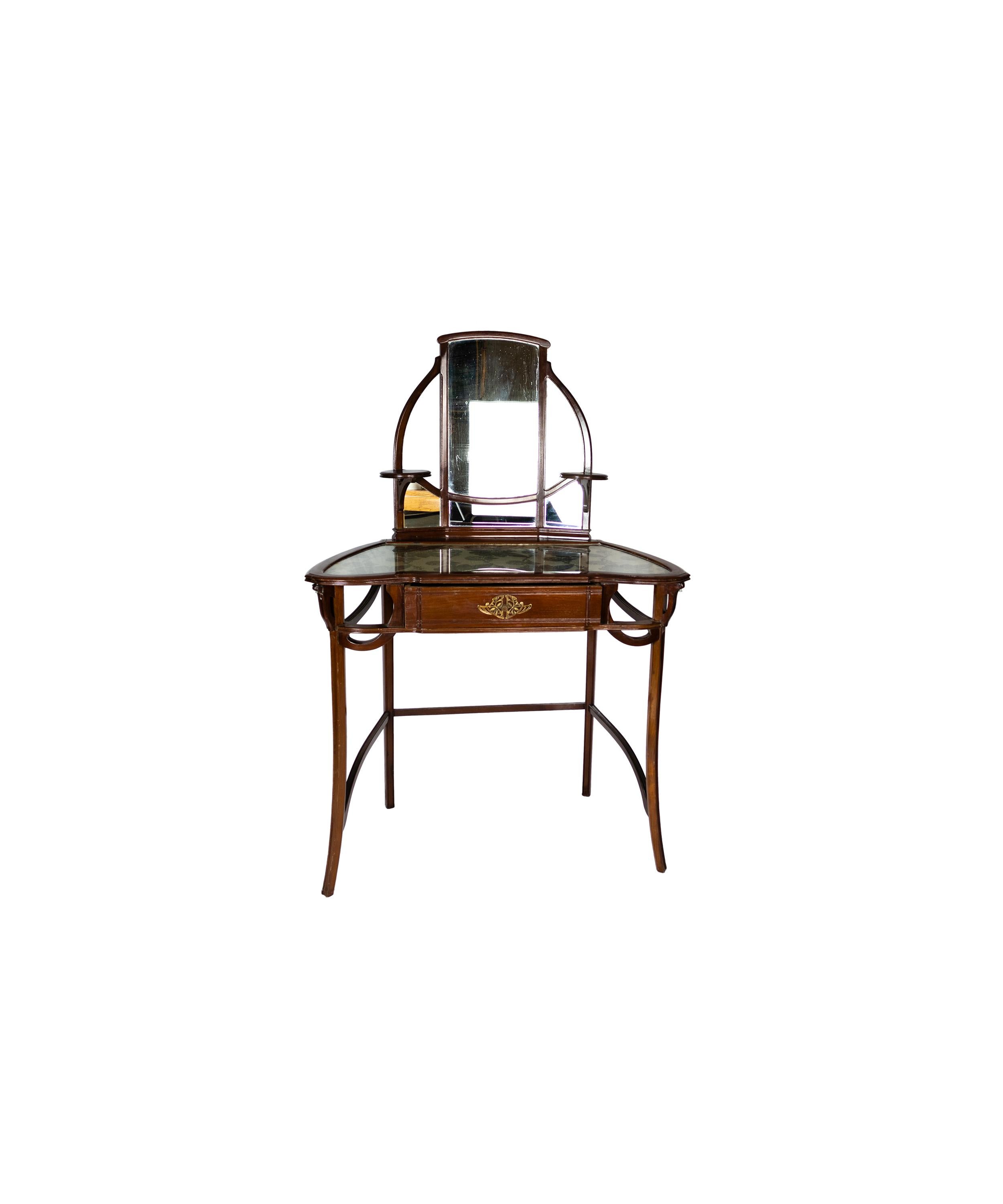 A french dressing table with mirror in cherry wood. 
An example of the elegance of Art Nouveau French design with a glass inlaid top and a mirror.
