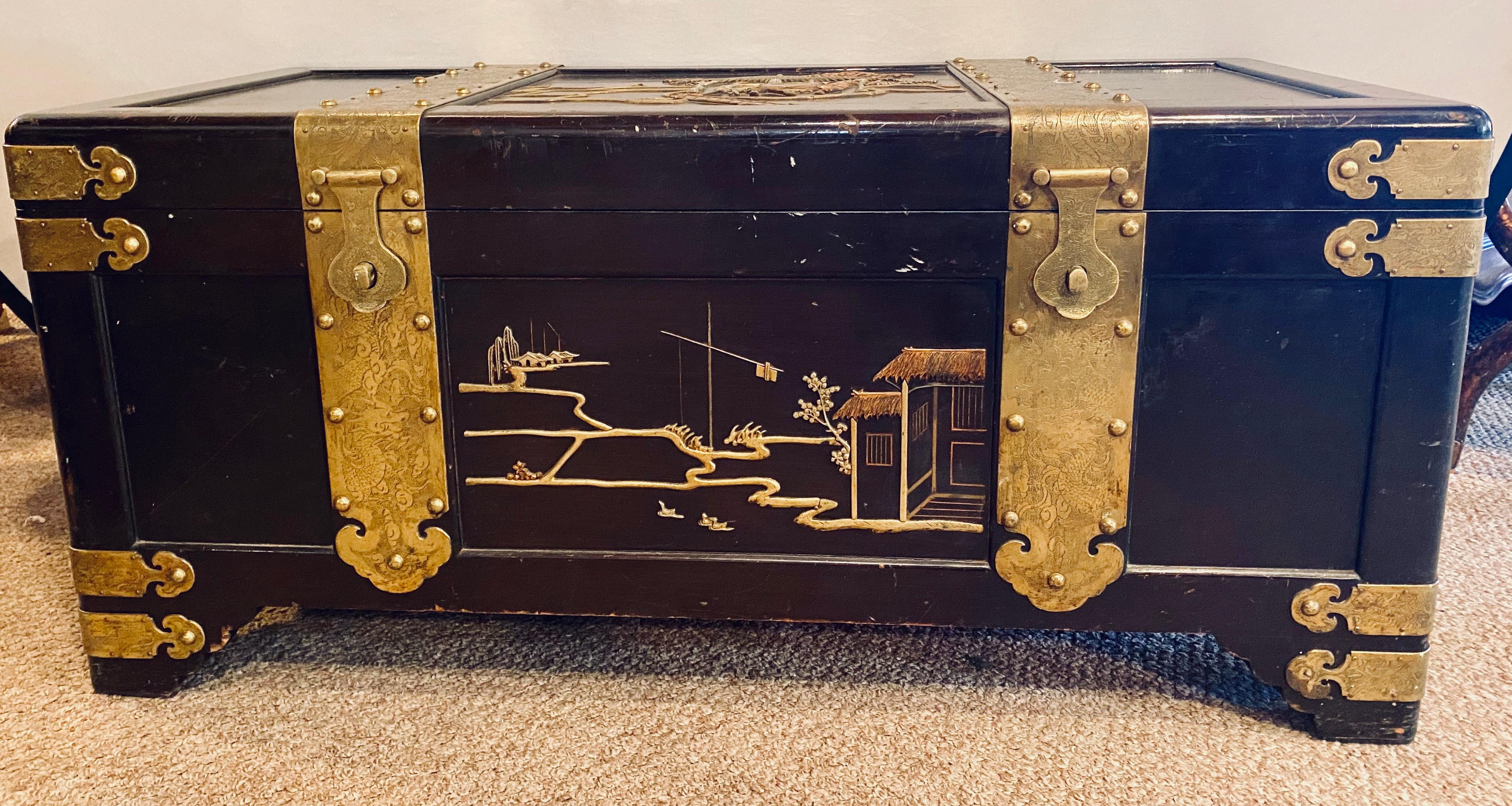 1920s Century Asian Dowry, blanket or storage chest. Bronze decorated having strong bronze hinges with a cedar interior this functional and decorative chest is simply stunning having an all over brass and copper design with camels, motifs and