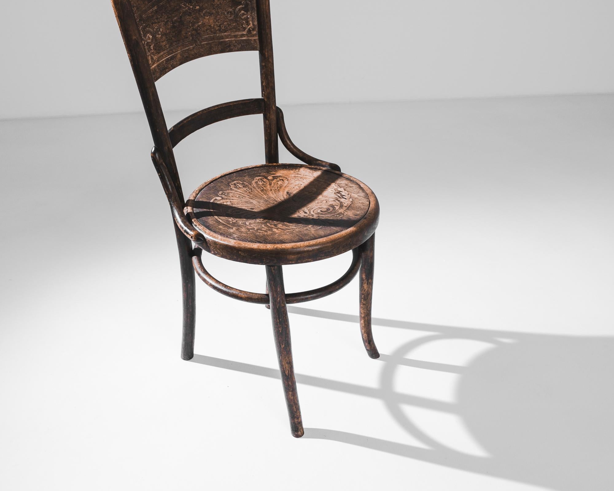 Erleben Sie den Charme der 1920er Jahre mit diesem Austrian Wooden Accent Chair. Dieses mit viel Liebe zum Detail gefertigte Vintage-Stück zeigt wunderschön gealtertes Holz, das eine Geschichte von Eleganz und Geschichte erzählt. Die klassisch