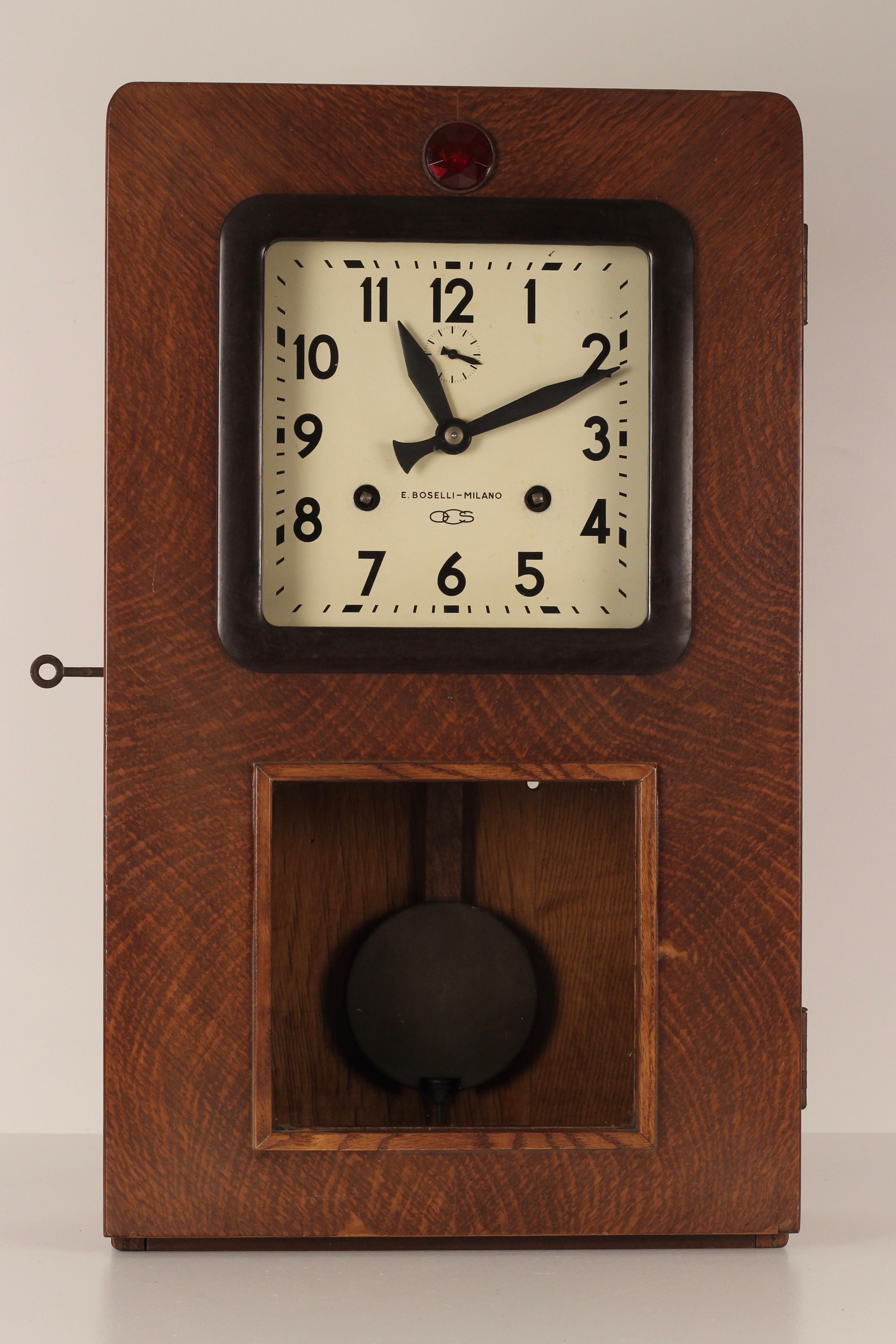 Rare Italian station wall clock, found in Rapallo in the Italian Riviera. Made from wood carcass with Plastic and Bakelite fascia, with a metal clock face and weighted pendulum.