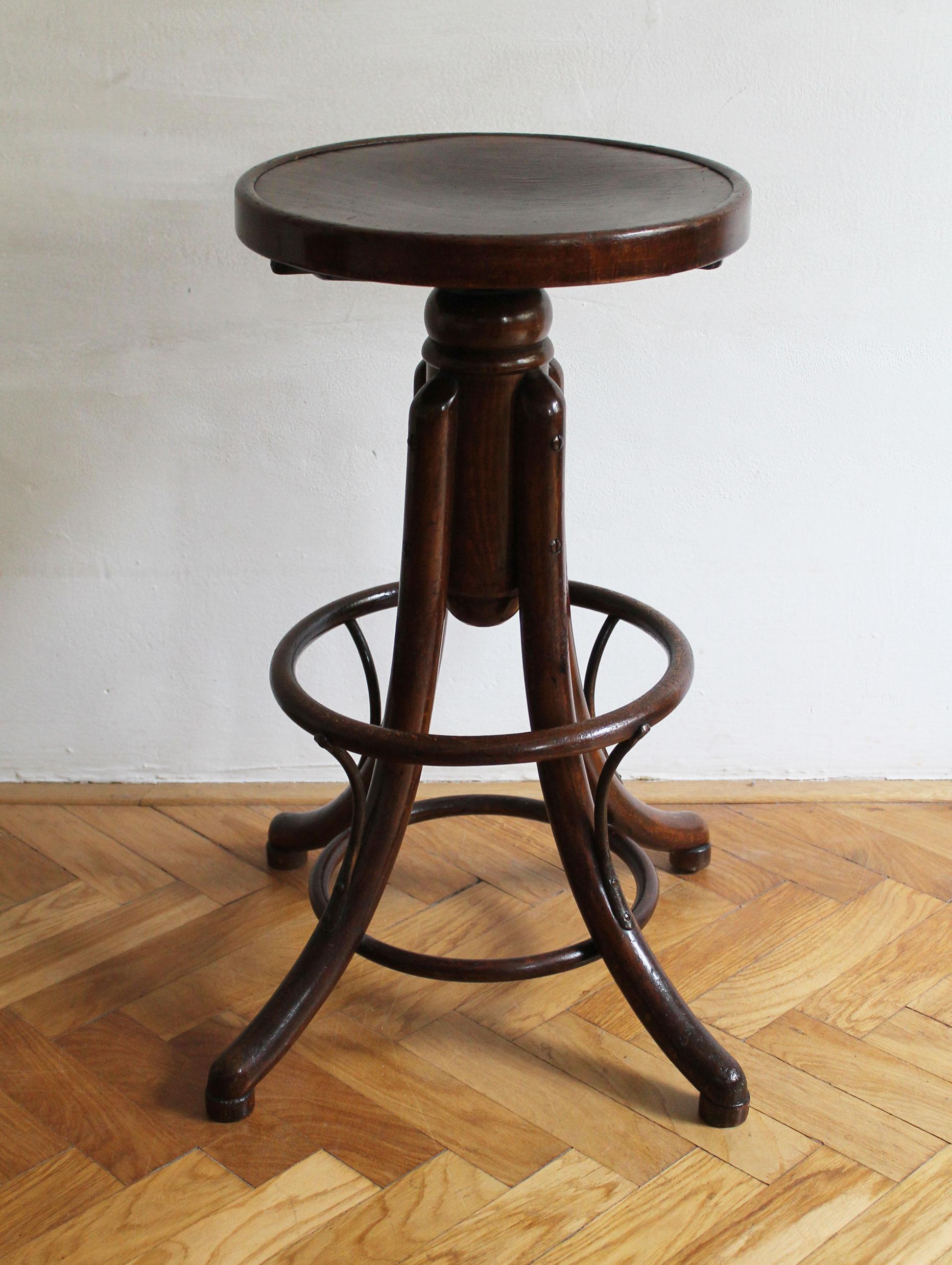This adjustable bentwood bar stool was designed and produced by the famous Thonet Company. The chair can be found in the Thonet sales catalogues dating back to the end of the 19th century as model No.5011 F. This particular piece is believed to be