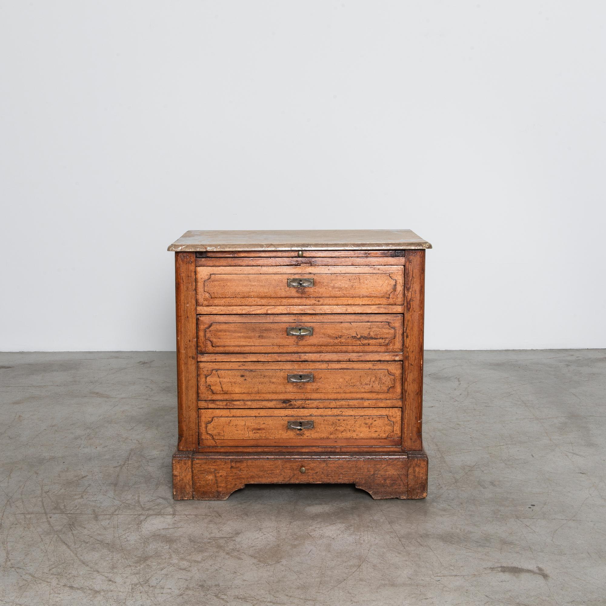 Step back in time with this exquisite 1920s Belgian Chest of Drawers, a true testament to timeless craftsmanship and elegance. This charming piece features a beautifully patinated faux marble top that adds a touch of sophistication and authenticity
