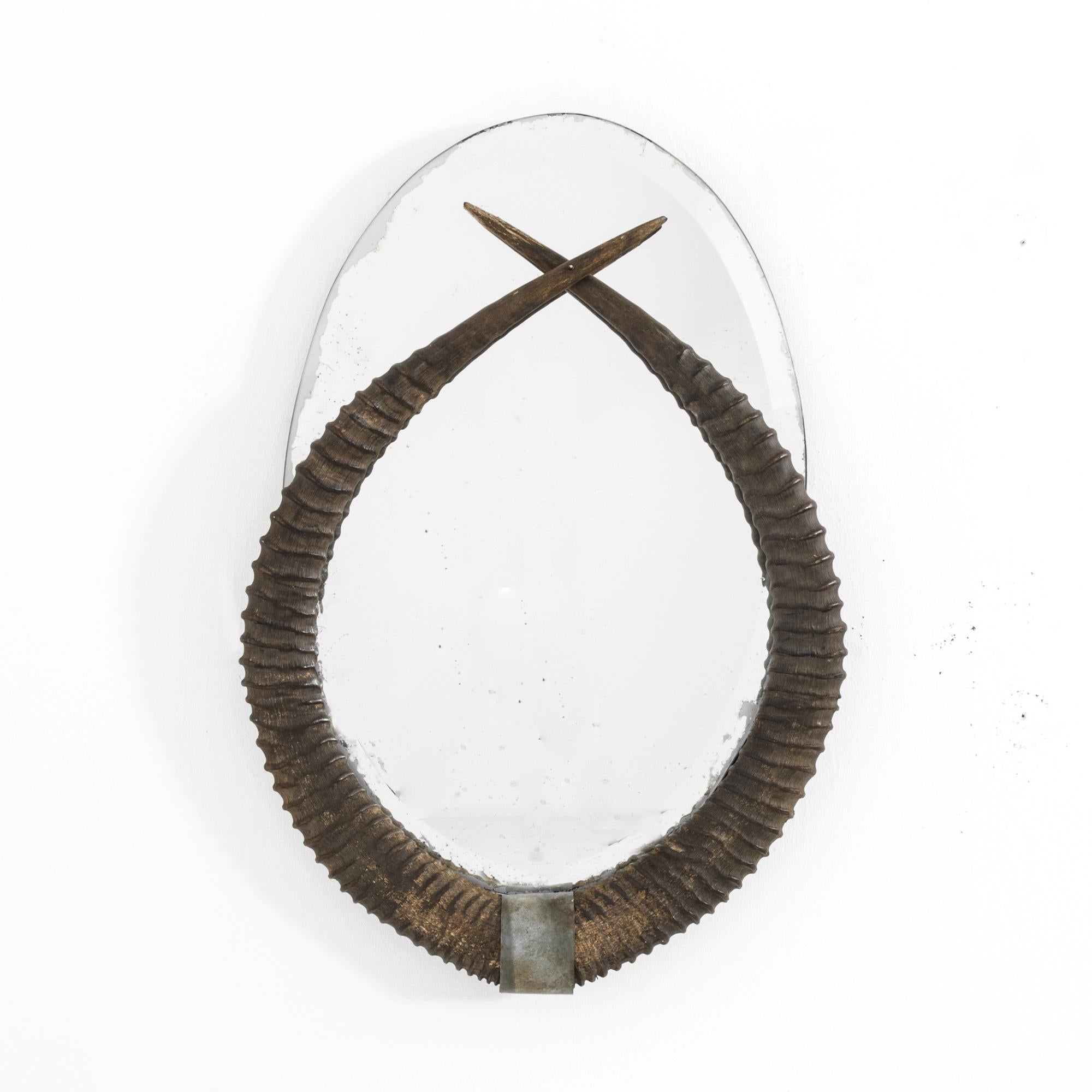 A decorative wooden mirror from Belgium, produced in the 1920s. Much like the masks of Picasso, this piece was inspired by contacts with other cultures. Its early modern design combines the clean look of a frameless mirror with the organic curves of