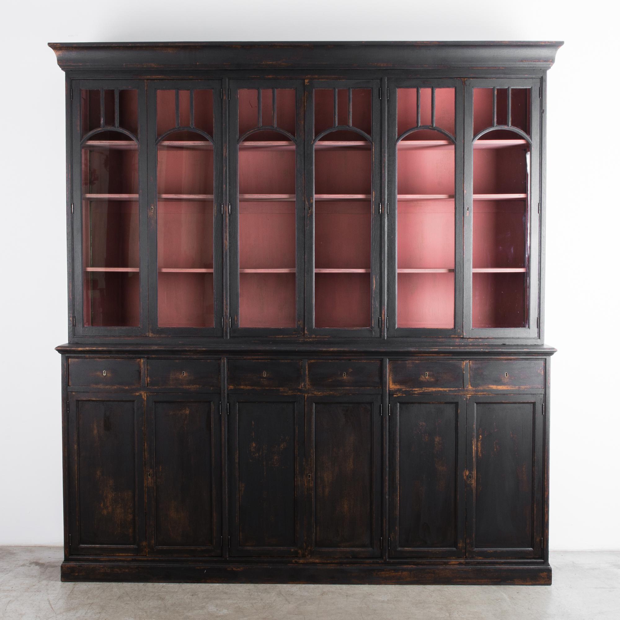 A well structured large cabinet from the Namur region of Belgium. Atmospheric dark color is supported by visual rhythm-- a pattern of vertical lines, enhanced by linear edge detail. Constructed in the tradition of regional furniture makers, with a