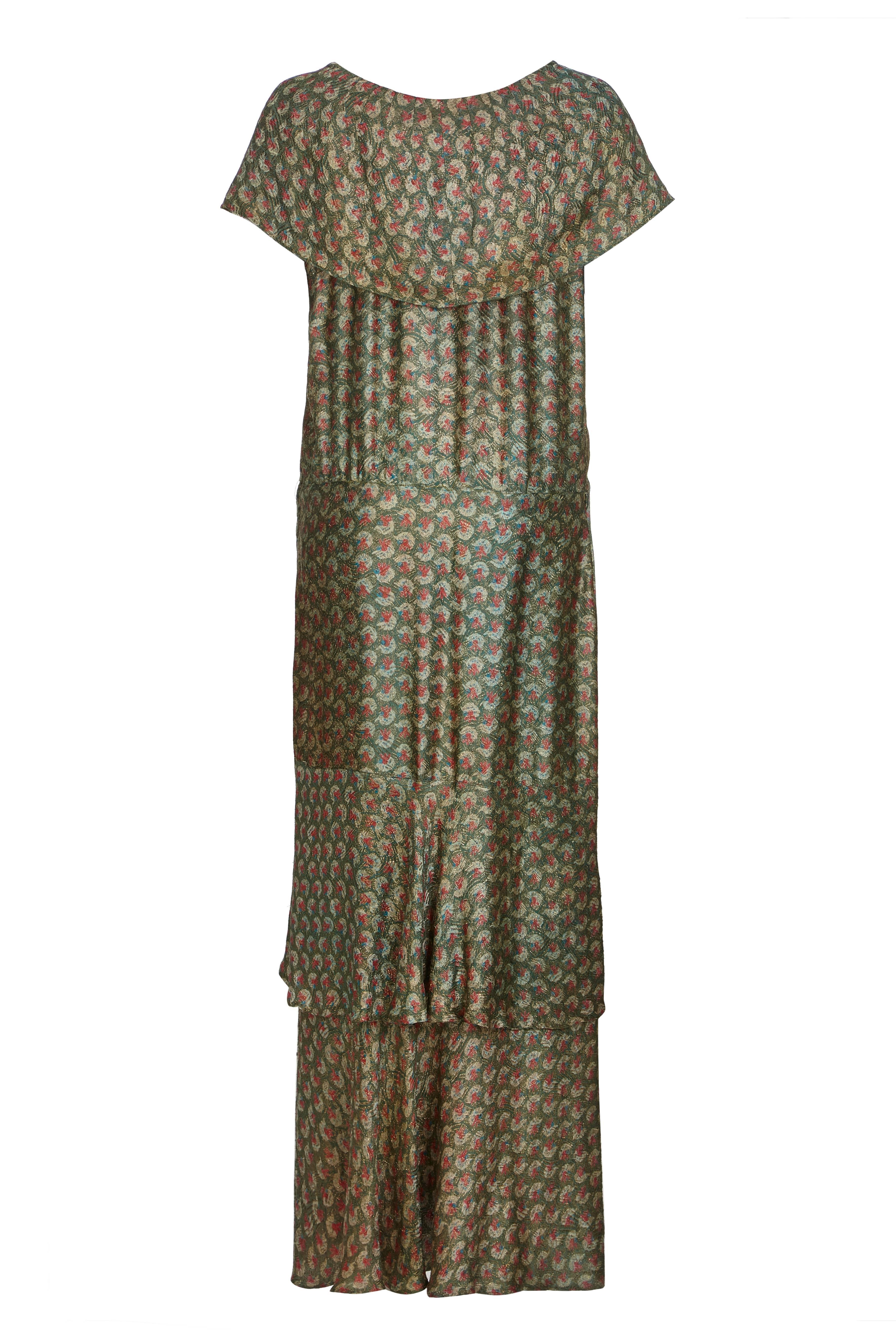 Original 1920s lame dress in gold, sage green, pale blue and dusk pink. Unlined, the fabric is light and airy, and the unusual construction of the gown creates a beautiful movement when worn. The soft boat neck at the front contrasts the stylish