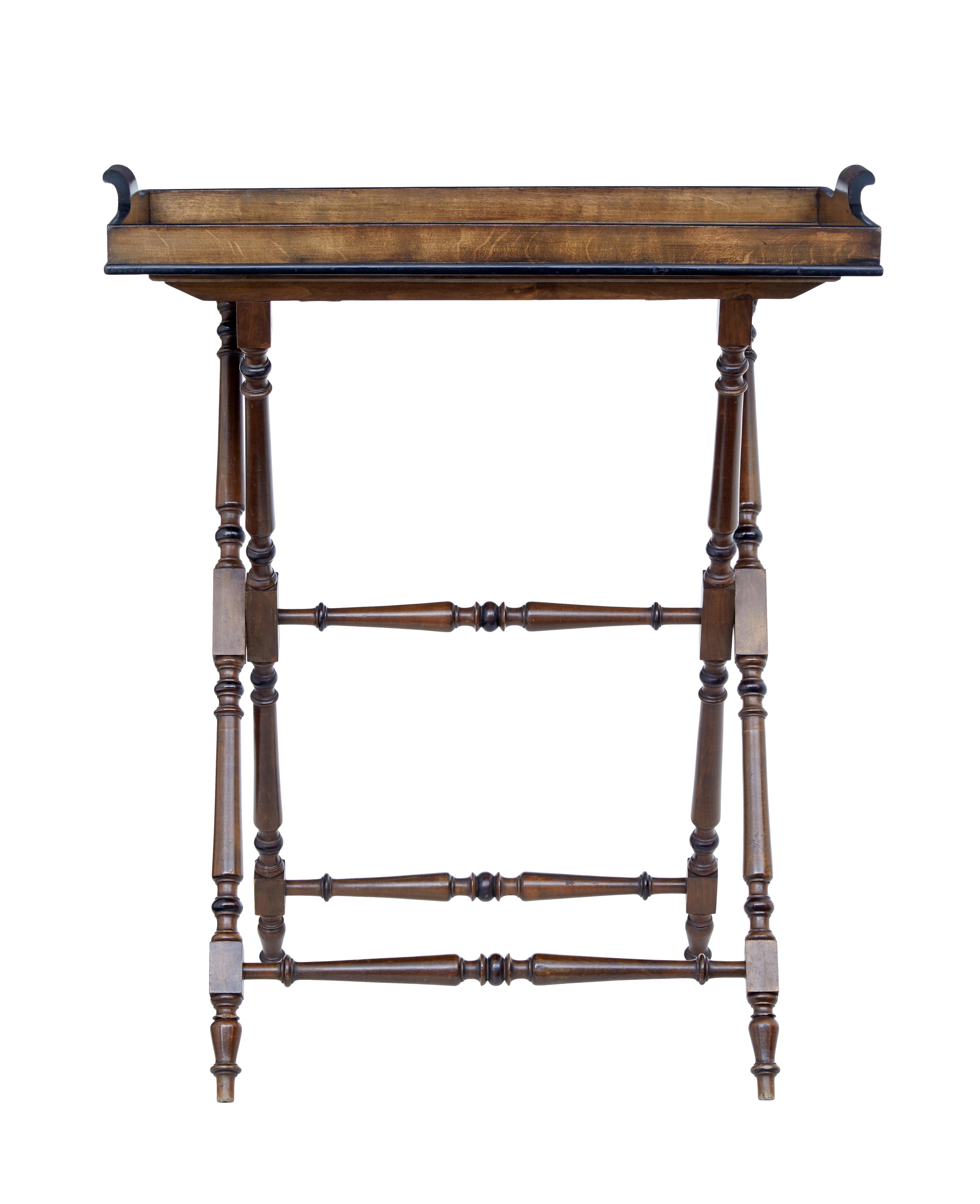 Early 20th century birch butlers tray on stand circa 1920.

Good quality piece of furniture ready for every use. Aside from it's original purpose it could function well as a lamp table. Dark stained pine tray with ebonization around the top and