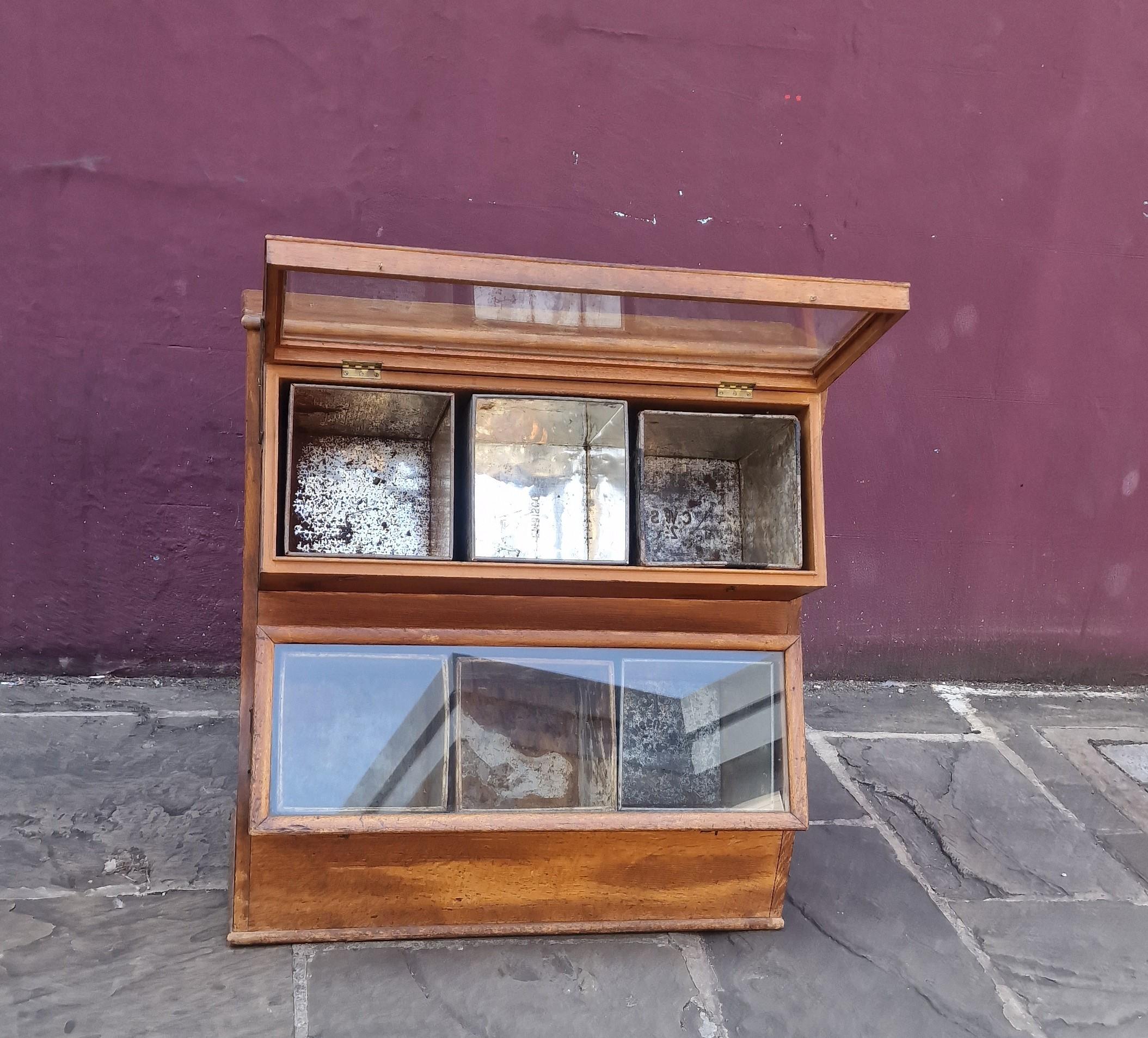 Vintage biscuit shop display cabinet fantaaric flexible strorage unit with original 6
Pull out tin boxes pull up glass doors Cc 20rh Century 