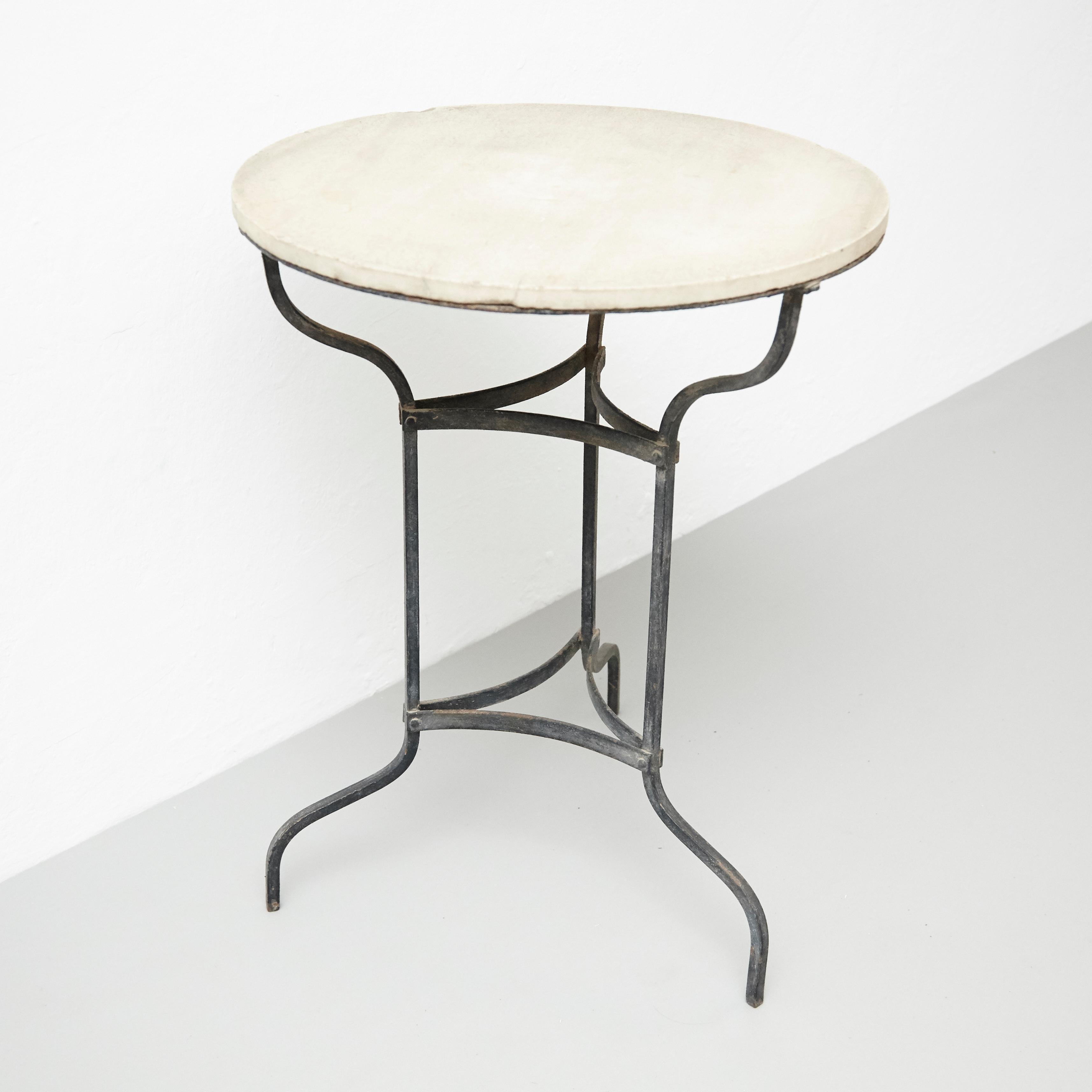 Bistrot metal and marble French table, circa 1920.
By unknown artisan, France.

In original condition, with minor wear consistent with age and use, preserving a beautiful patina.

Materials:
Marble
Metal

Dimensions:
D 60 cm x W 60 cm x H