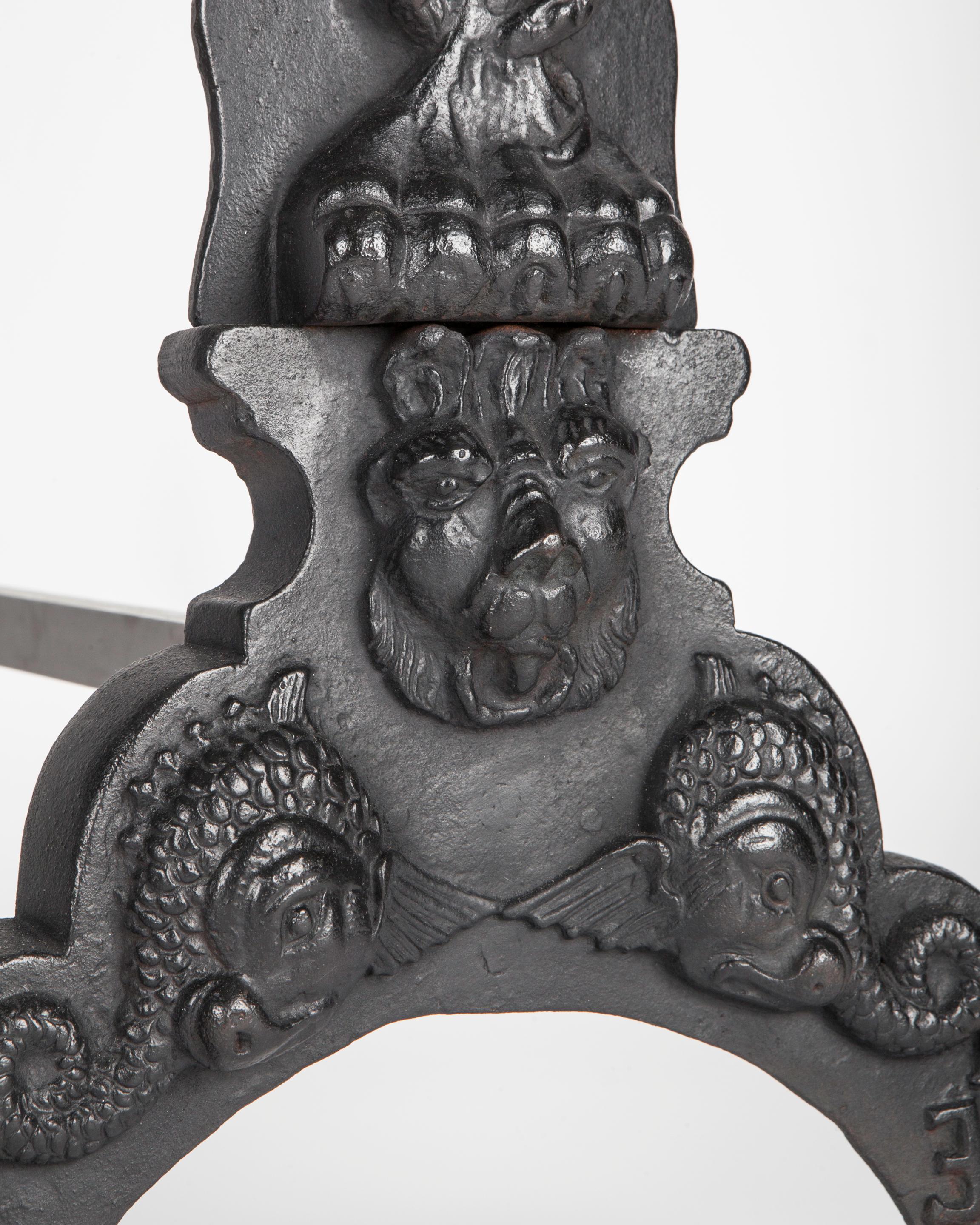 Renaissance 1920s Black Cast Iron Andirons with Figures of a Hybrid Atlas over a Caduceus For Sale