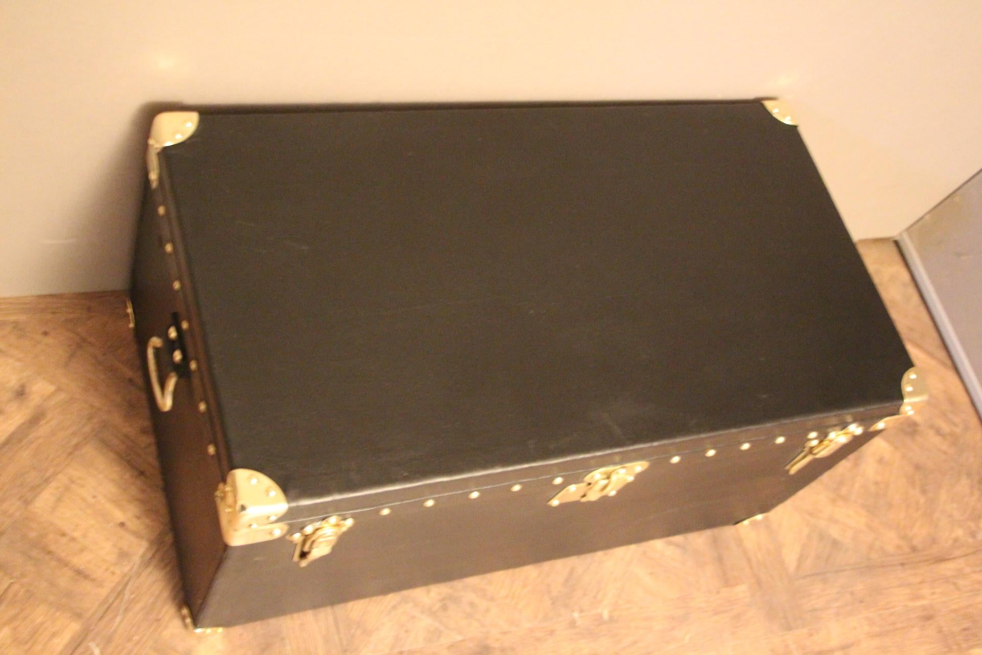 This very nice Louis Vuitton auto trunk in black canvas, features stamped LV solid brass locks and studs and leather side handles.
Original interior.
Perfect size to be used as a coffee table or side table.
   