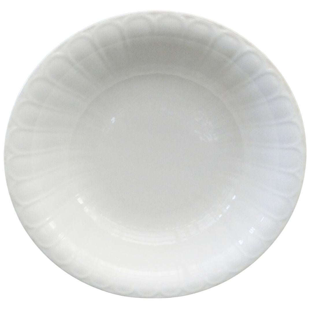 Handcrafted in the 1920s, this Boch Freres bowl is the perfect vessel to serve up a delicious salad, to use as an everyday fruit bowl, or to pile with moss for a lush centerpiece. The bowl has a scalloped design on the rim with descending lines