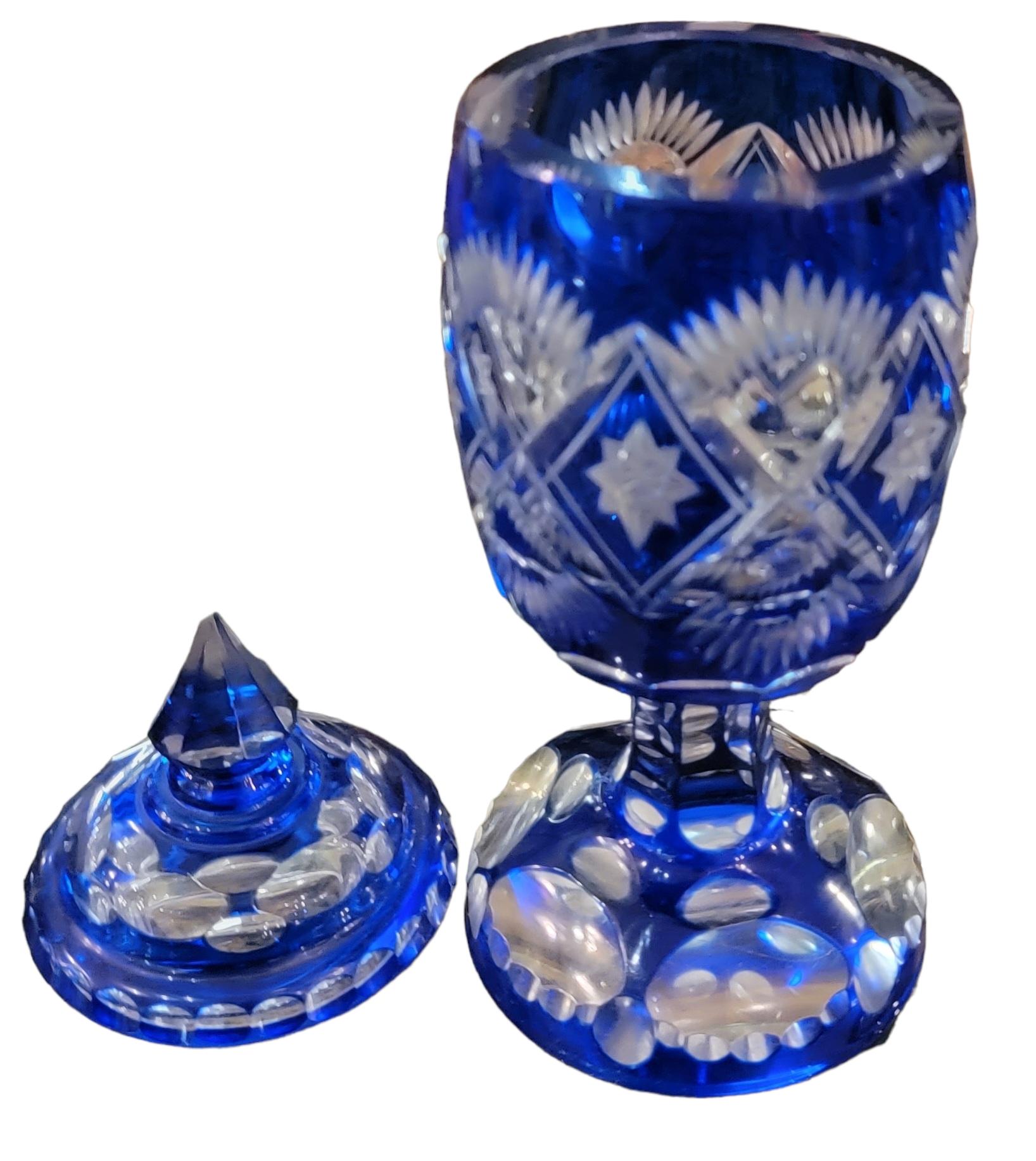 1930s Bohemian Heavily carved Lidded Jar with transparent cobalt blue coloring. measures approx - 9.5 h x 3.25diamter
