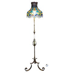 1920’s Brass And Iron Floor Lamp With Antique Tiffany Style Swirl Shade