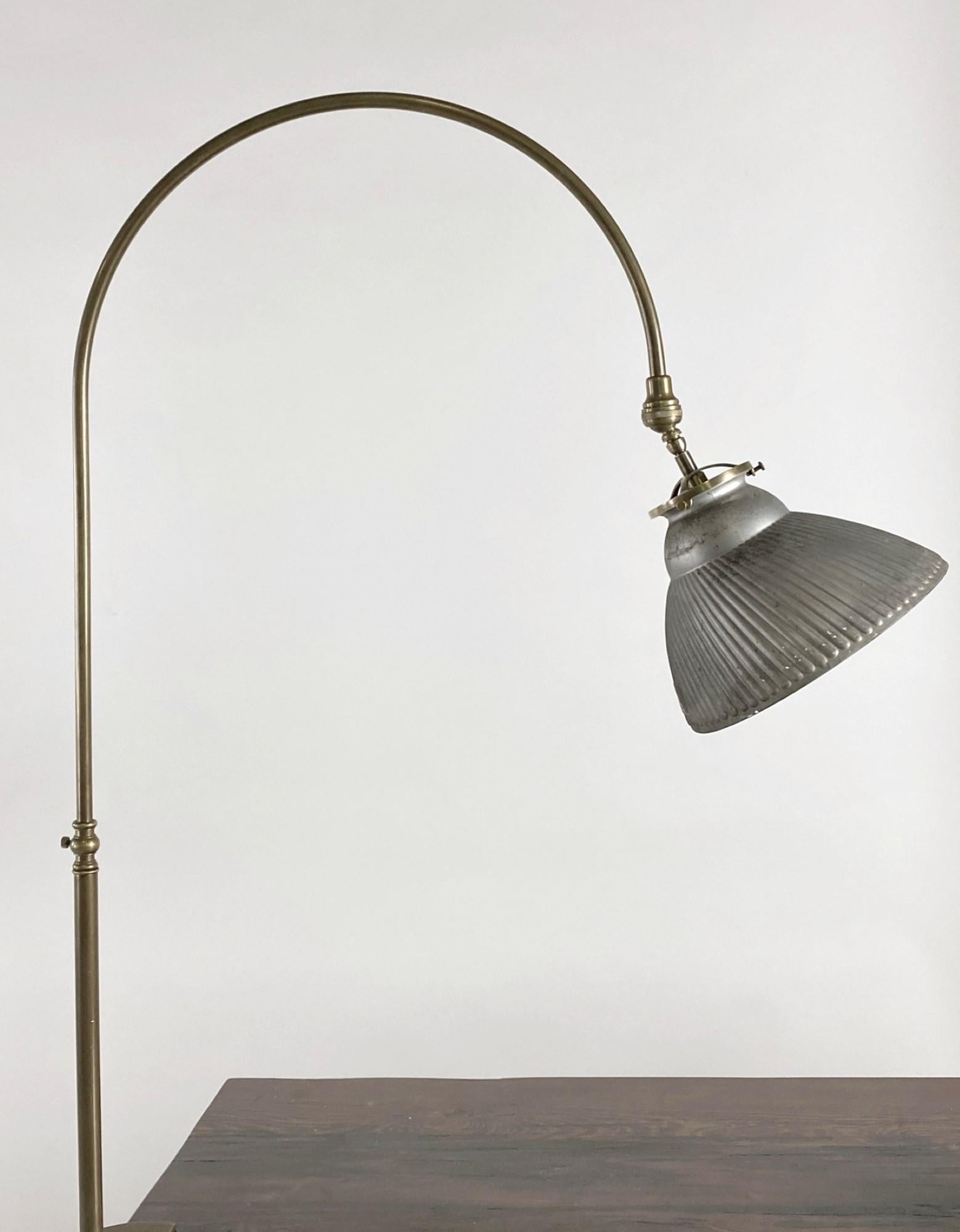 1920s gooseneck desk lamp made from brass with a mercury glass shade. Features a 10 foot cord with a thumb switch. Uses a normal household lightbulb. Priced each. Small quantity available at time of posting. Priced each. This can be seen at our 400